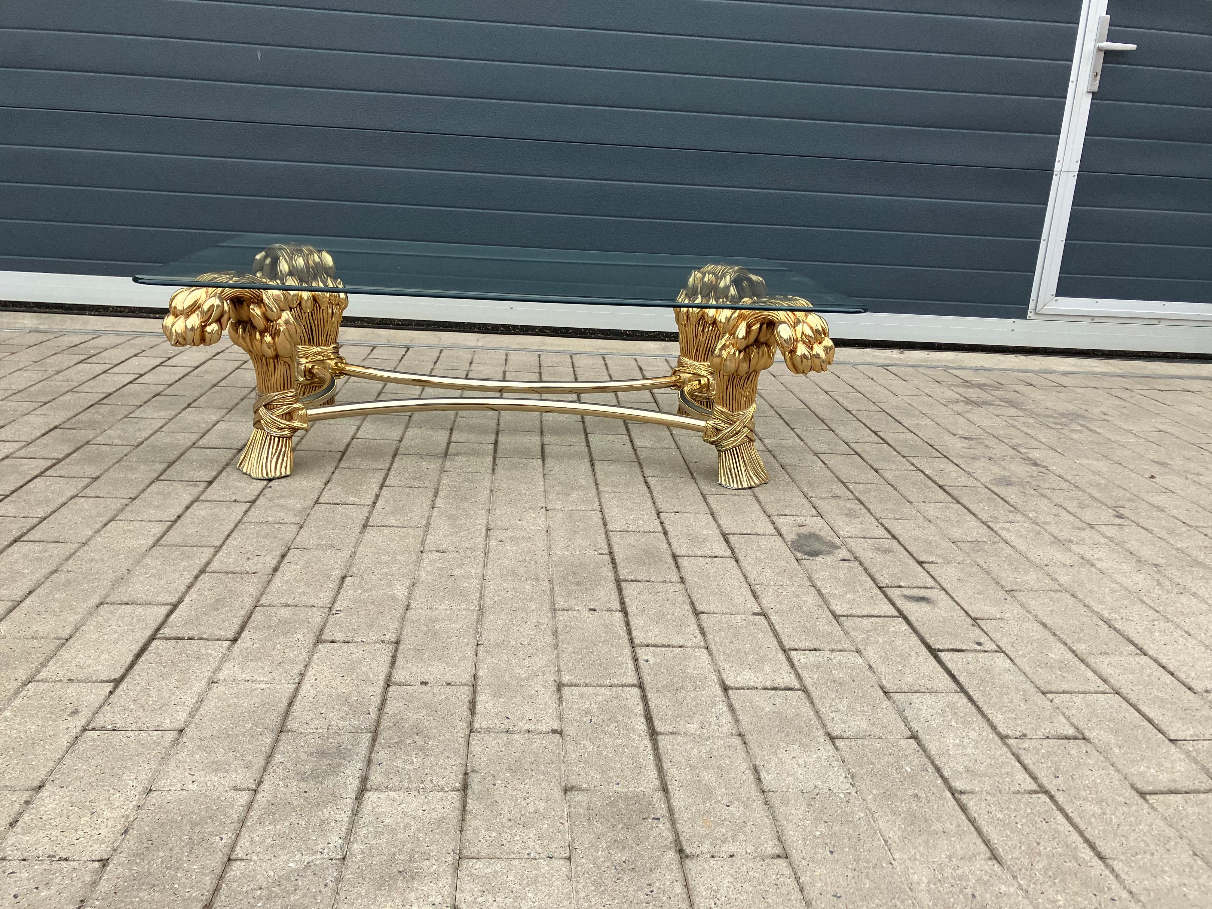 Magnificent Hollywood Regency Tulip (Flowers) Coffee Table from the 70’s by the famous Belgian artist Willy Daro (also well know for the Brass Bonsai tree Coffee Tables).

Brass Coffee Table with a glass top.
In beautiful vintage condition!
A