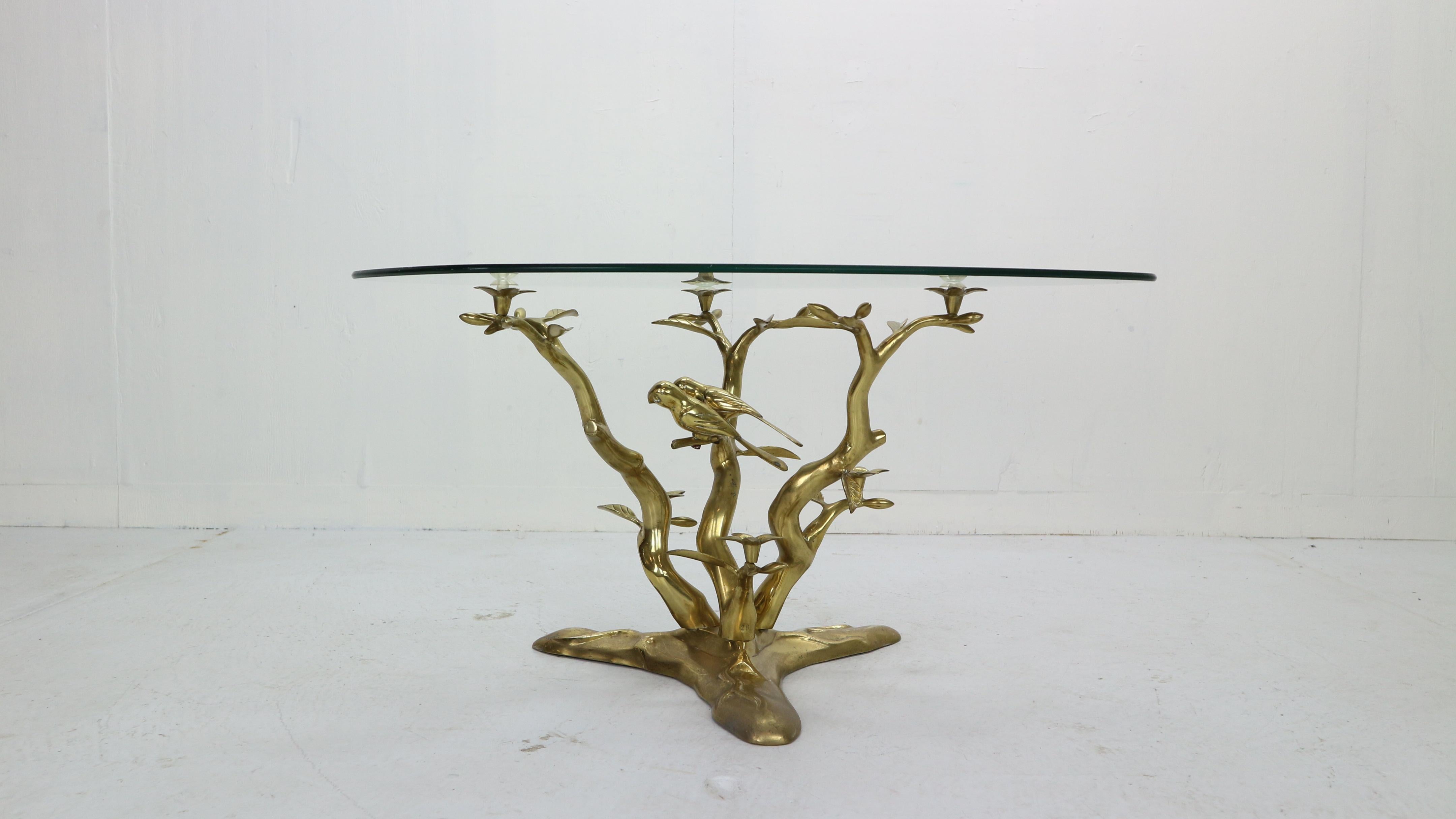 Hollywood Regency period stunning coffee table designed by Willy Daro in 1970s, Belgium.
Brass sculpture base with tree, birds and flower elements and glass top.
 