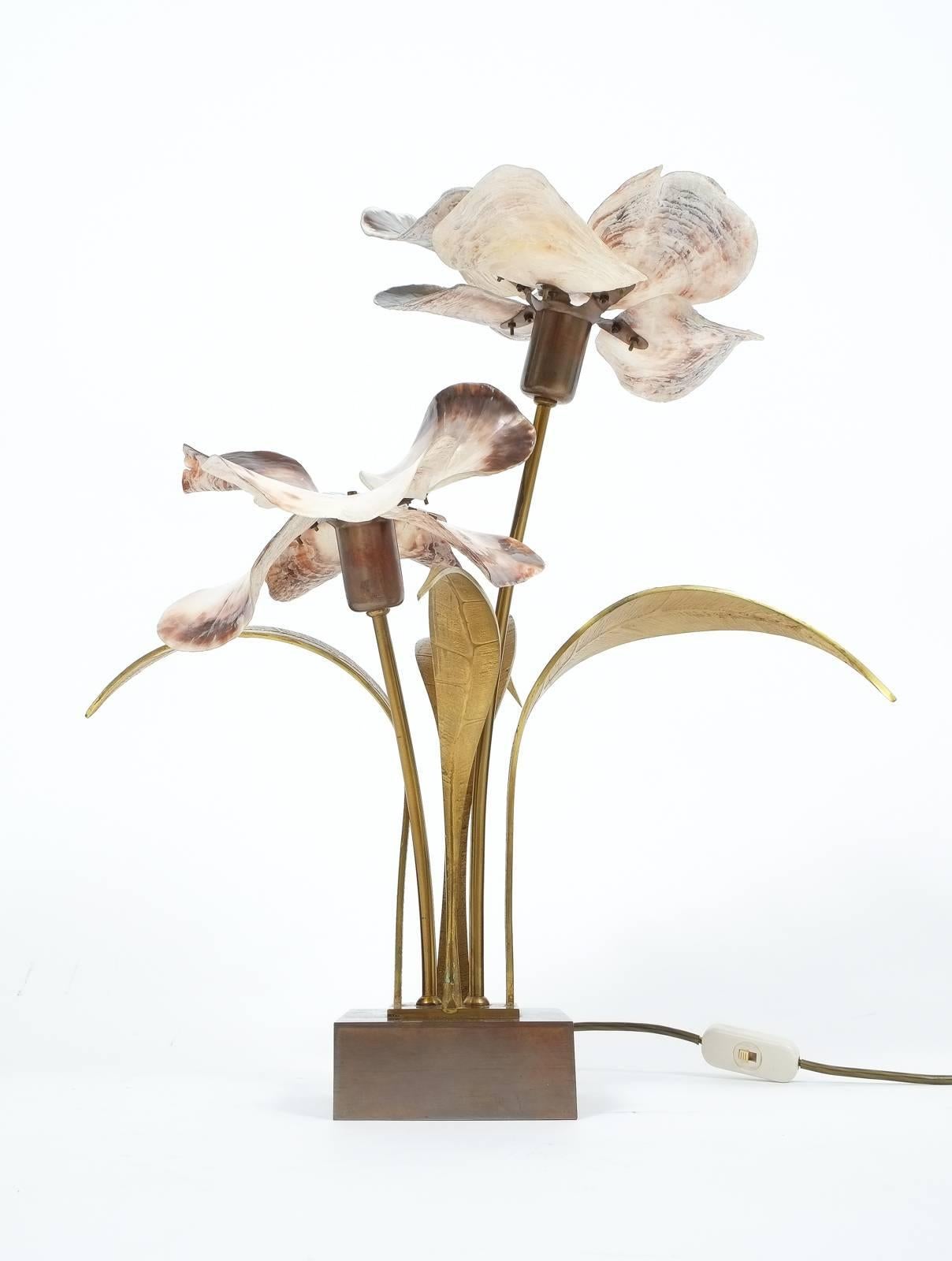 Beautifully table light by Willy Daro consisting of a bronze socket with brass leaves and capiz shell petals. The light has been executed with great love for material and detail. The condition is very good, with no chipping. Matching gold-tip bulbs