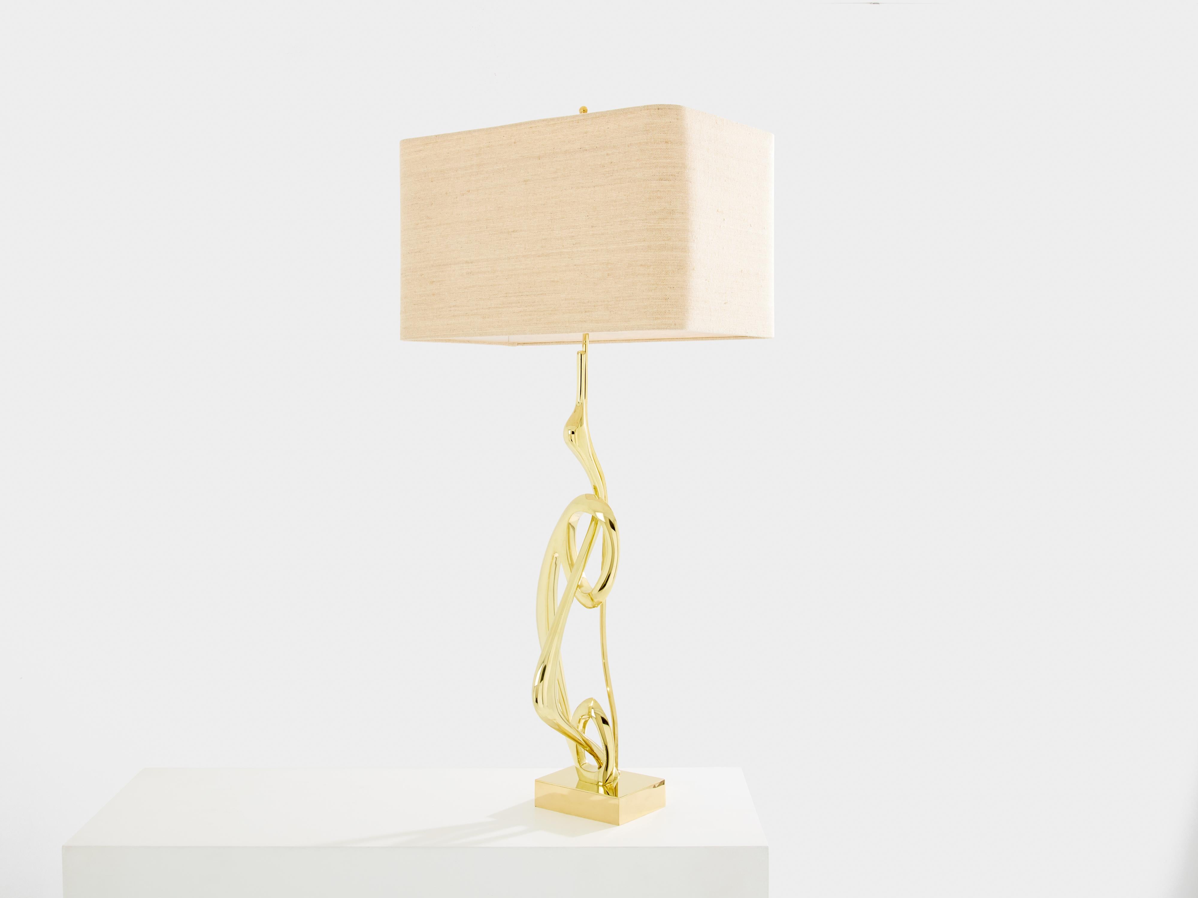 This tall bronze table lamp was designed and produced by Willy Daro in the 1970s. It has the visual impact of a modernist sculpture. This rare model is made of solid polished bronze, shaped like a thin bird. The result is the impression that this