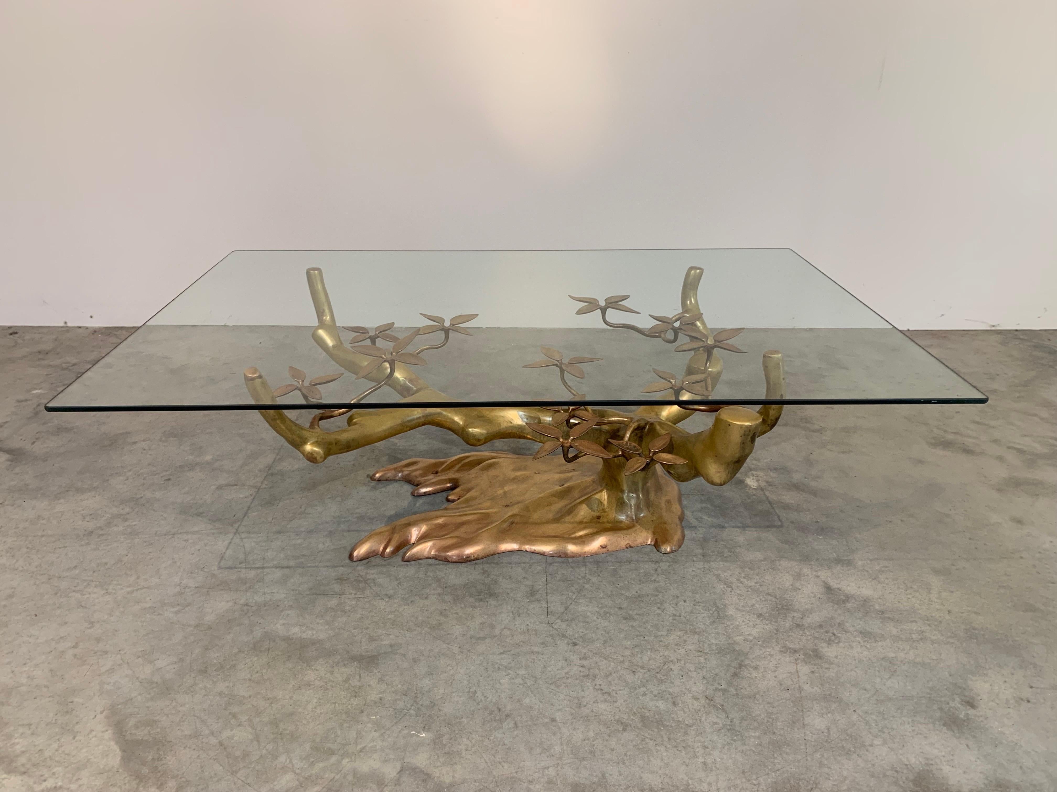 A beautiful sculptural brass coffee table designed by Willy Daro and manufactured in Belgium circa 1970 having ‘Bonsai’ sculpture base under tempered glass. 
In outstanding vintage condition. Freshly polished and glass cleaned. 
16.5x46.5x30.75” HWD