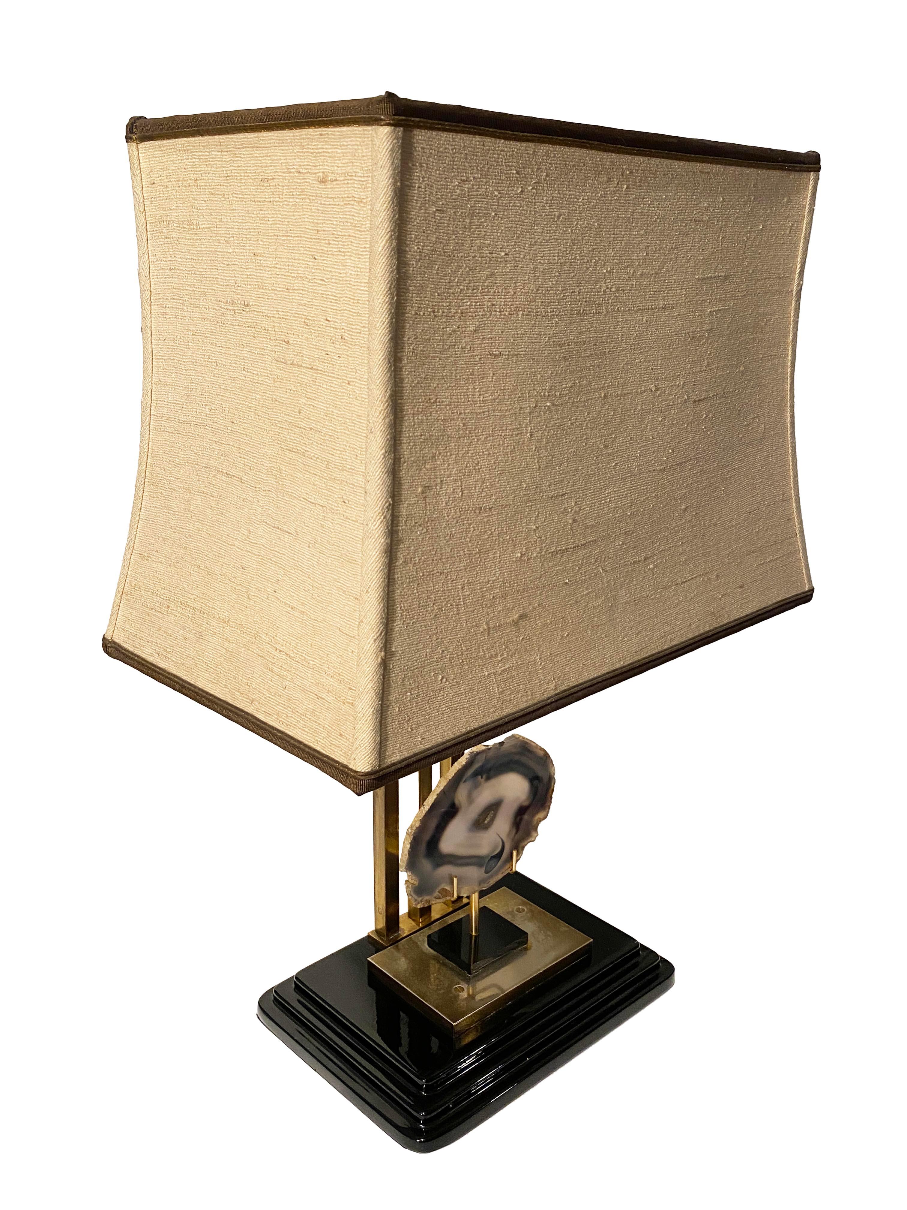 Elevate your interior with this exceptional and rare table lamp, designed in the iconic style of Willy Daro. This striking piece features a unique loose agate stone set as the focal point within the sculptural brass base—a hallmark of Daro’s