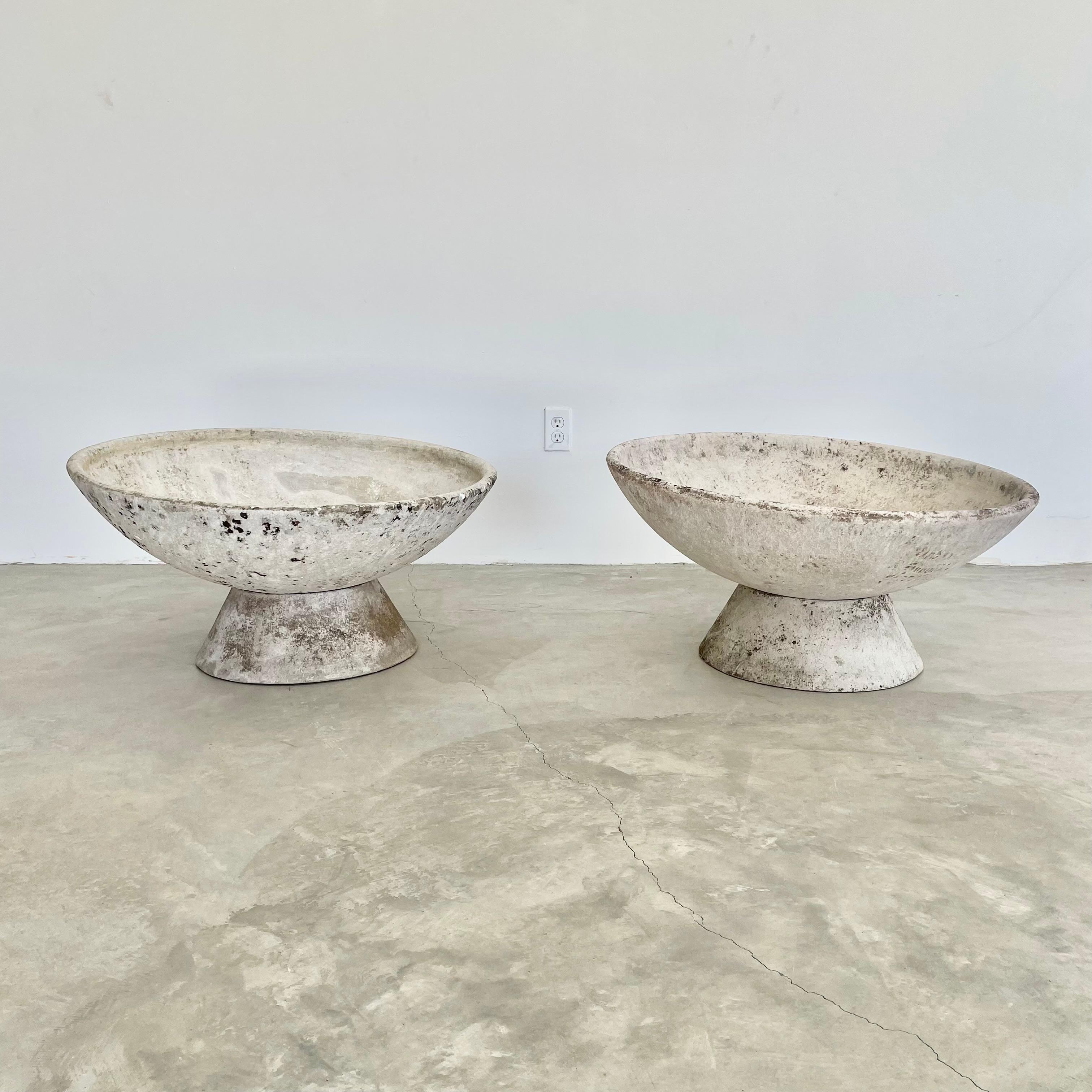 Fantastic cement planters by Swiss designer Willy Guhl for Eternit. Pedestal base with massive bowl that sits on top. Bowl can sit flat or angled in a multitude of directions. Great for indoors or outside. 20 available. Priced individually.
