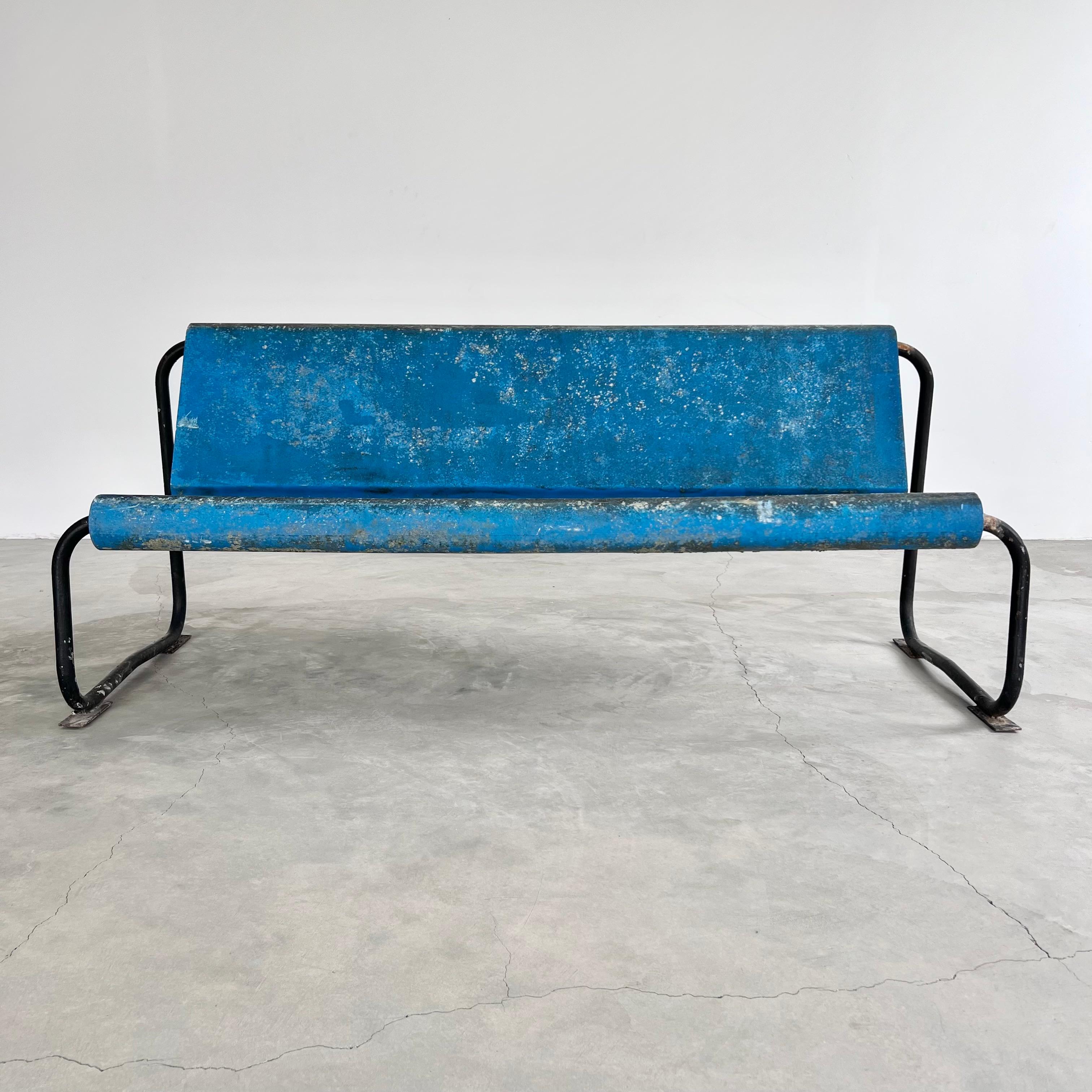 Remarkable midcentury floating bench by Swiss Architect Willy Guhl. circa 1960s. Perfect minimal design as is common with the Swiss designer. Light weight but sturdy. The electric blue seat is made of fiberglass and is suspended by a black tubular