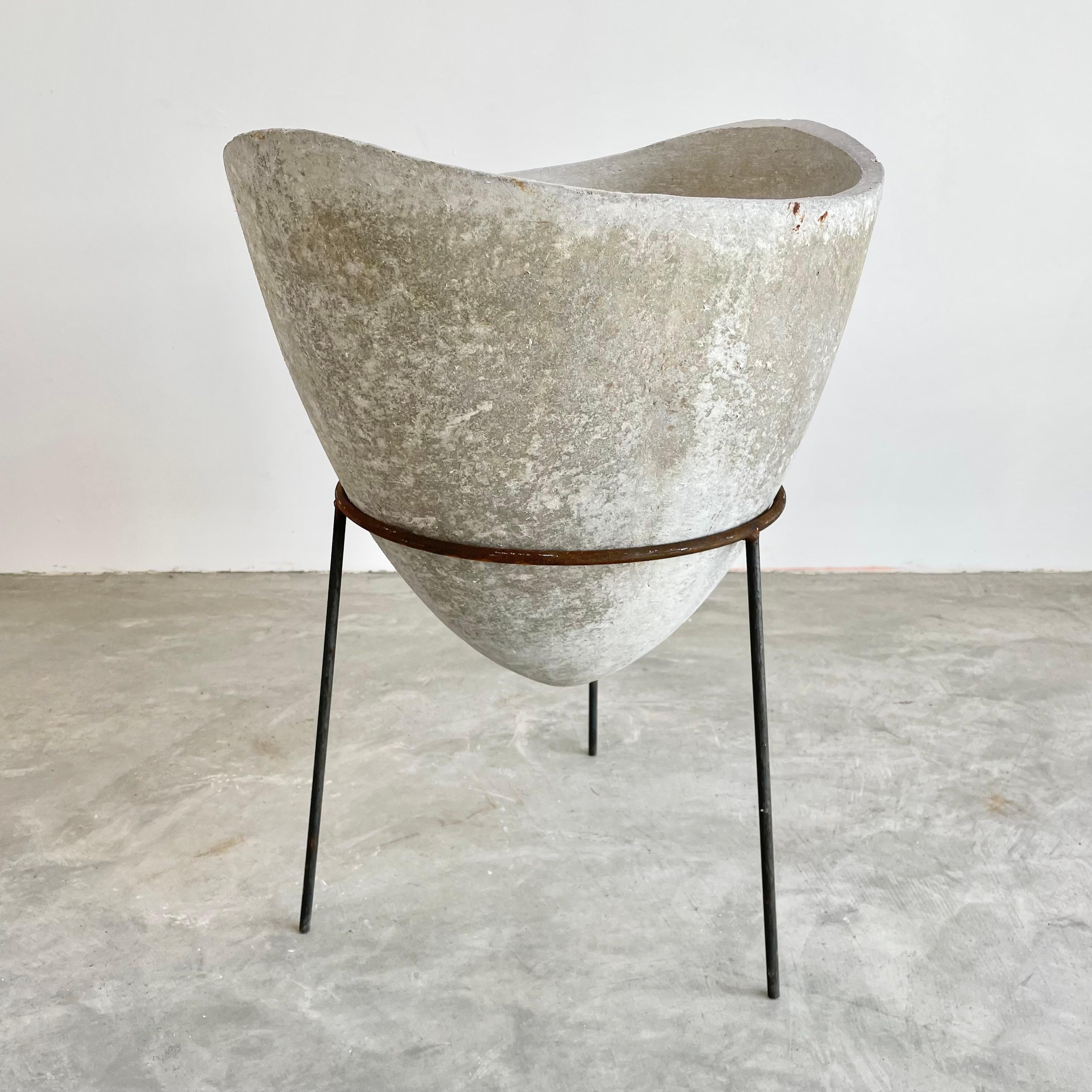 Rare and unusual biomorphic bowl planter by Willy Guhl made in the 1960s  Switzerland. Thick concrete frame with undulating top edge. This inverted bowl sits comfortably in a tall iron tripod stand. Clean patina to planter and great color to iron.
