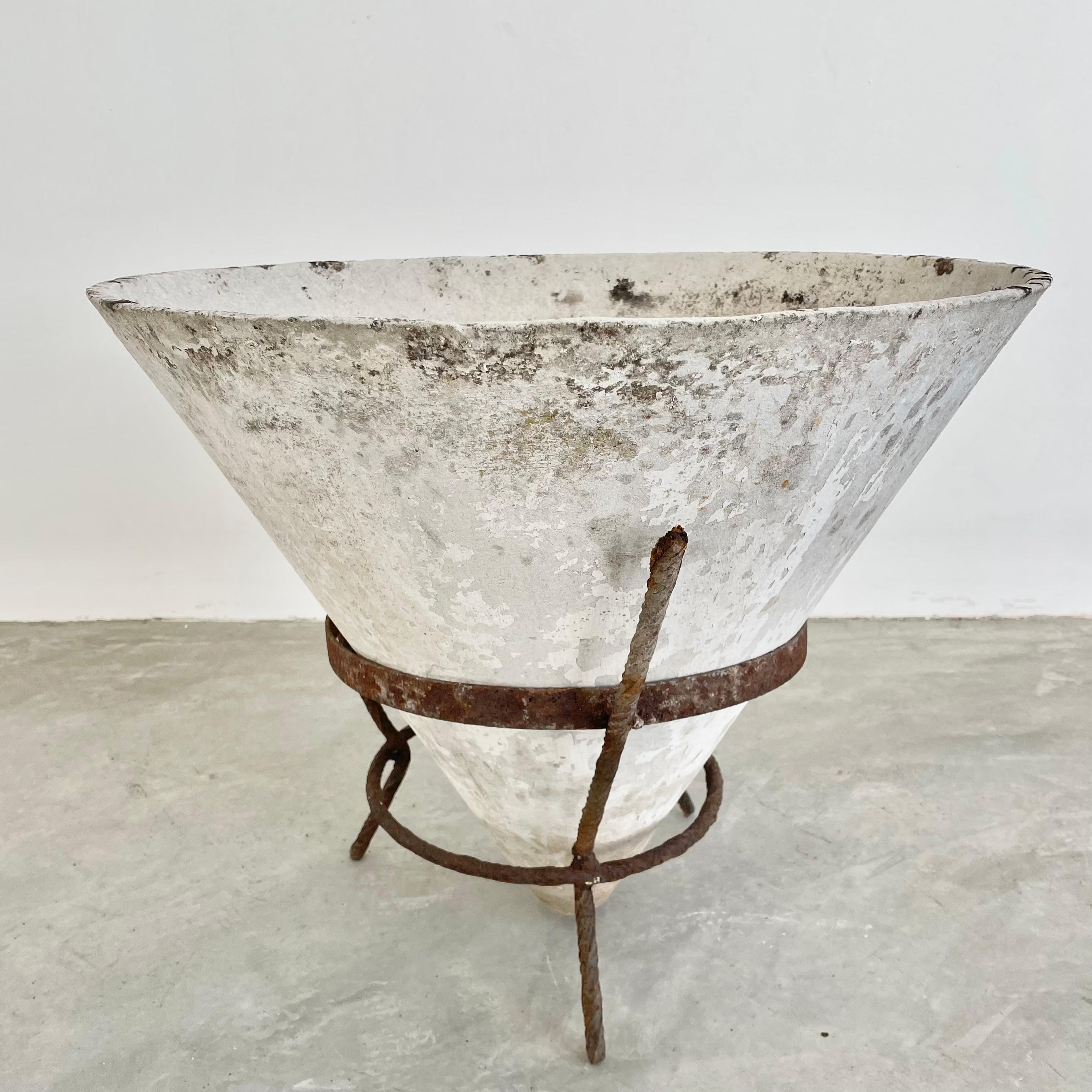 Cone planter by Willy Guhl made in the 1960s, in Switzerland. Inverted concrete cone sits comfortably in an iron tripod stand. Great patina and coloring to planter and the iron stand. Bottom of cone floats about an inch off of the ground.