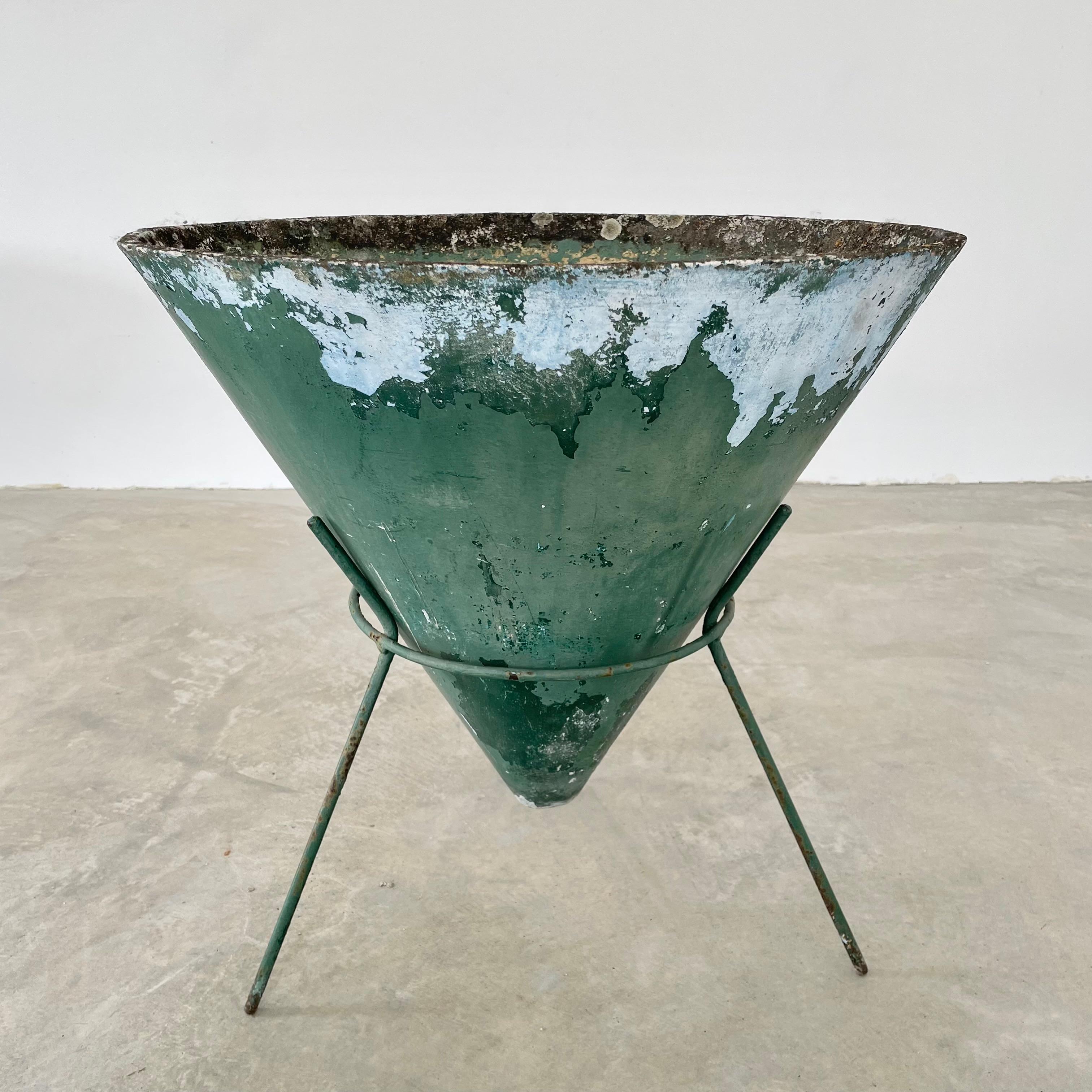 Green cone planter by Will Guhl made in the 1960s, Switzerland. Inverted concrete cone sits comfortably in an iron tripod Stand. Great patina and layers of green coloring to planter. Bottom of cone floats a few inches off of the ground. 4 matching