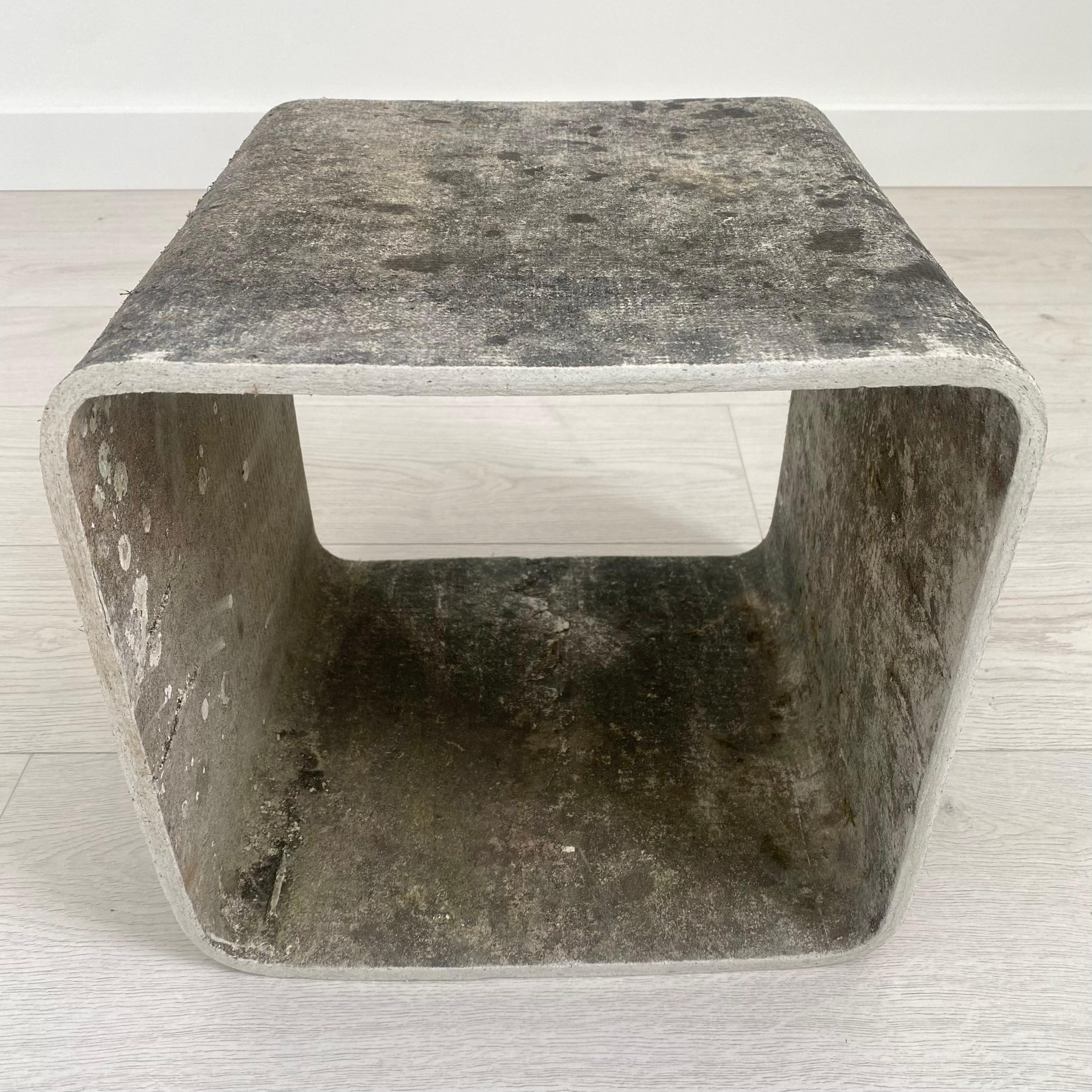 Sculptural concrete cube side table by Swiss architect Willy Guhl. Handmade in Switzerland in the early 1960s. Produced by Eternit. Age and weather has given this piece an inimitable patina. Sturdy and well made. Beautiful piece on its own or a