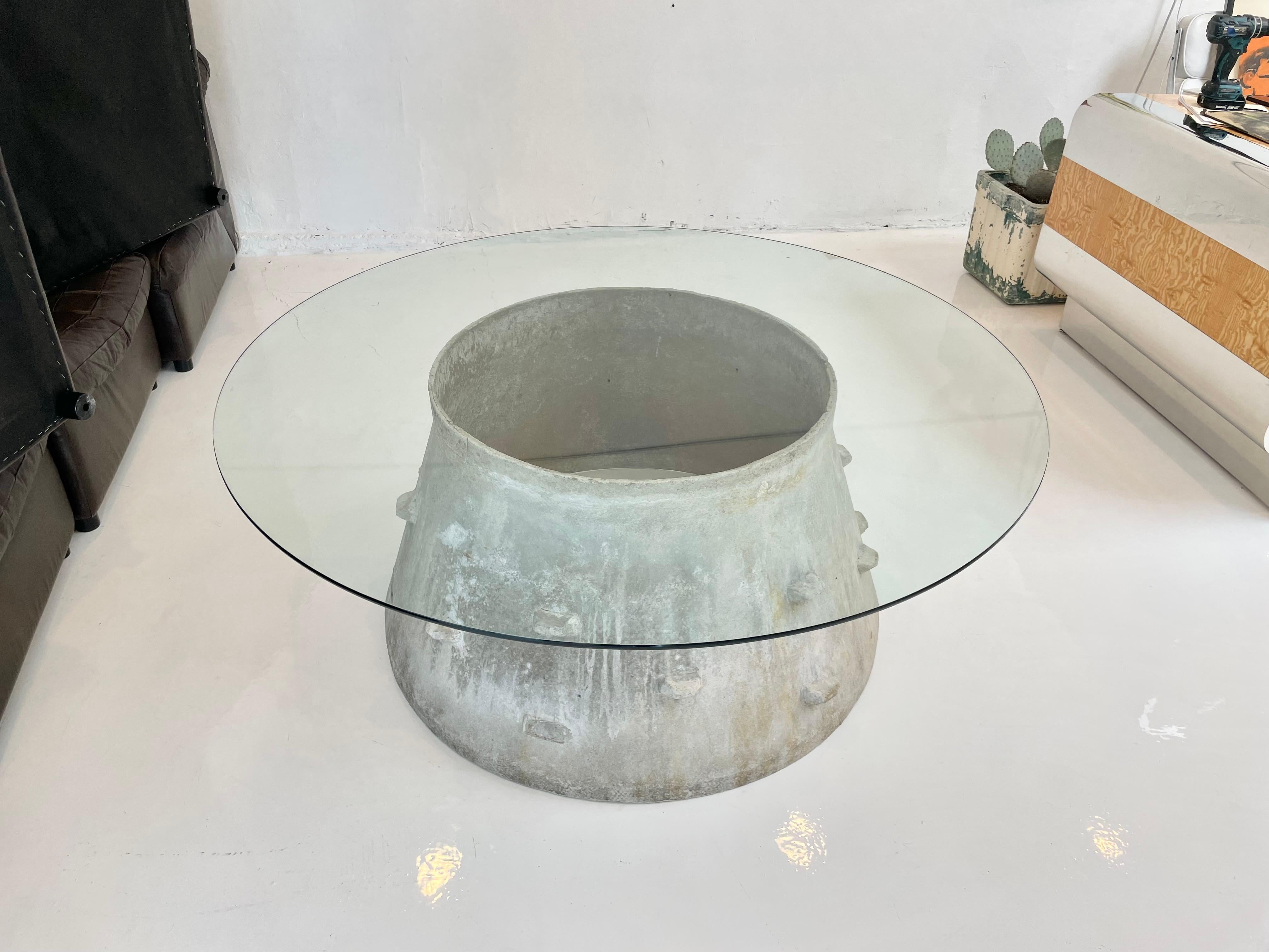 Fantastic drum table by Swiss architect Willy Guhl for Eternit. Great scale and unique shape. Suitable for indoor and outdoors. Only one available. New pencil edge glass top. Stunning sculptural table. 

 The base dimensions are 28