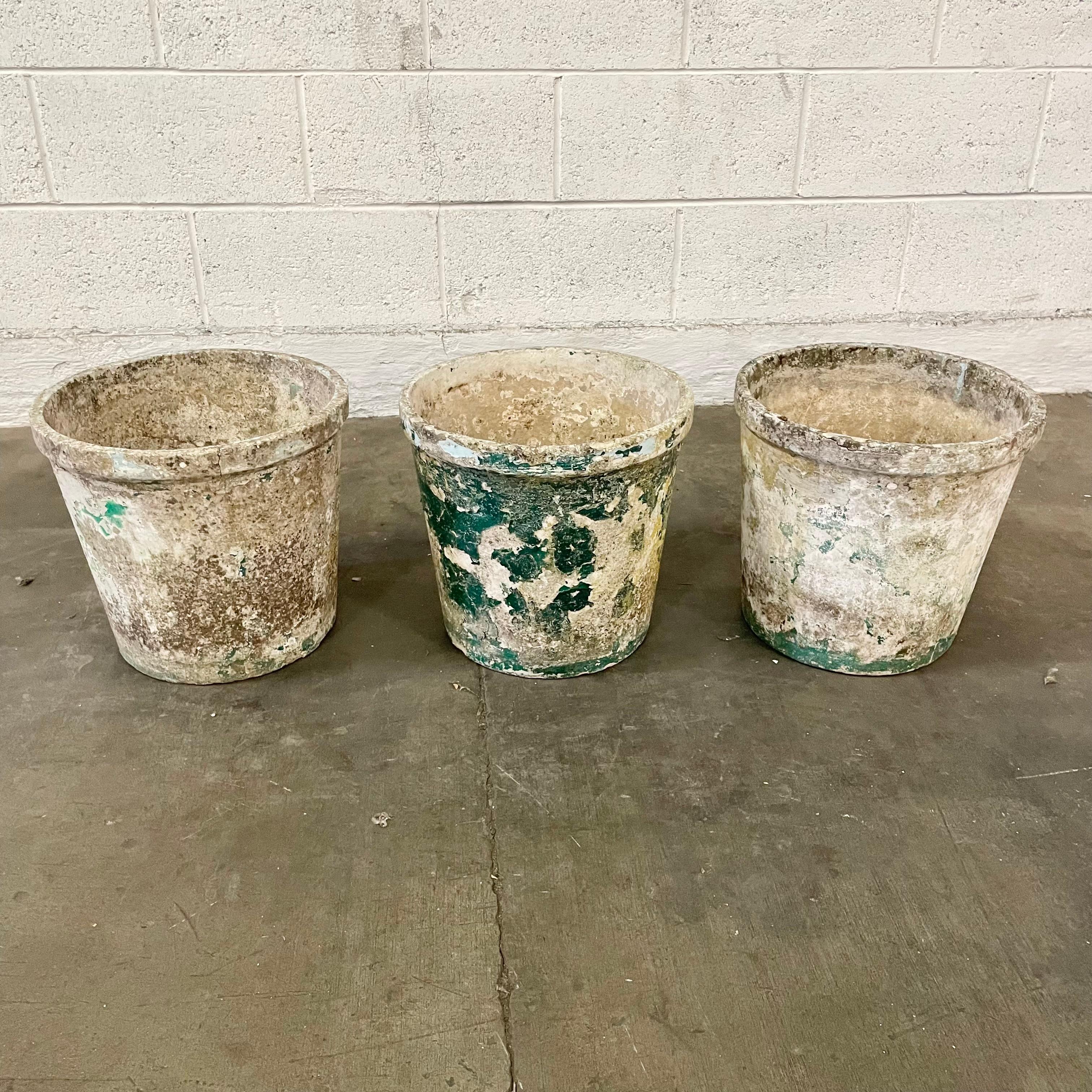 Perfect large concrete flower pots by Willy Guhl. Made in Switzerland in the 1960s. Great vintage condition with unique patina on each as shown. Classic flower pot design with large basin and banded lip at the top. 3 available. Priced individually.