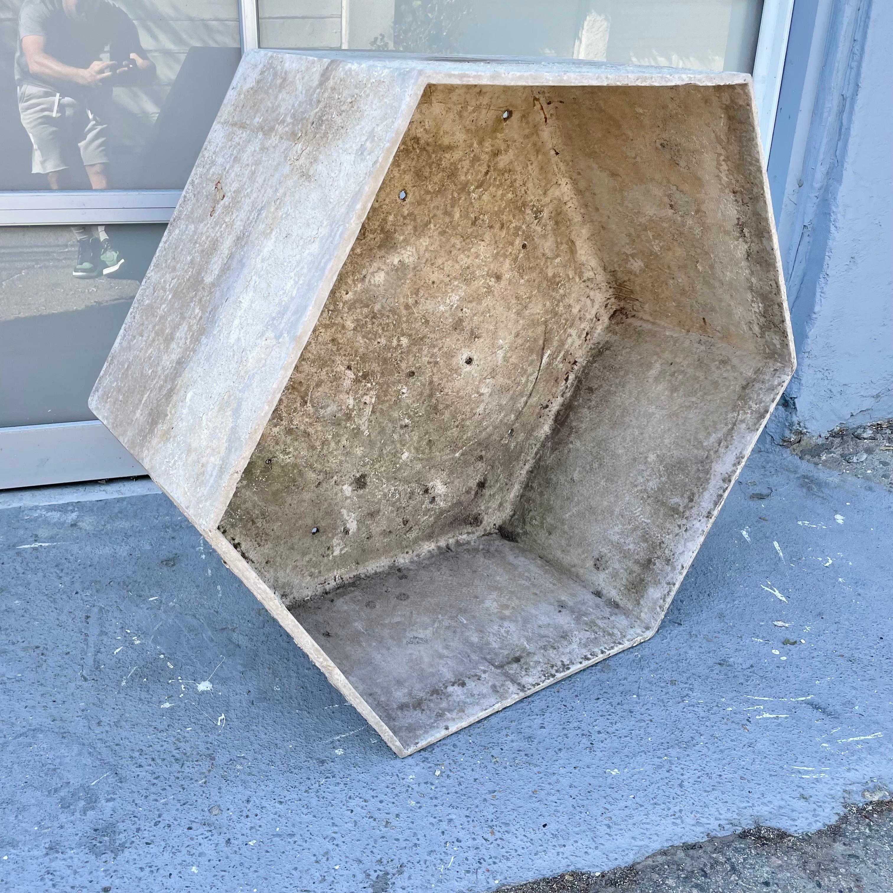 Monumental concrete hexagon planter by Willy Guhl. Handmade in Switzerland. Dated 1986. Powerful presence and patina. Factory drilled drainage holes. Unusual shape. Very good condition. Great lines. Cool piece of outdoor sculpture.