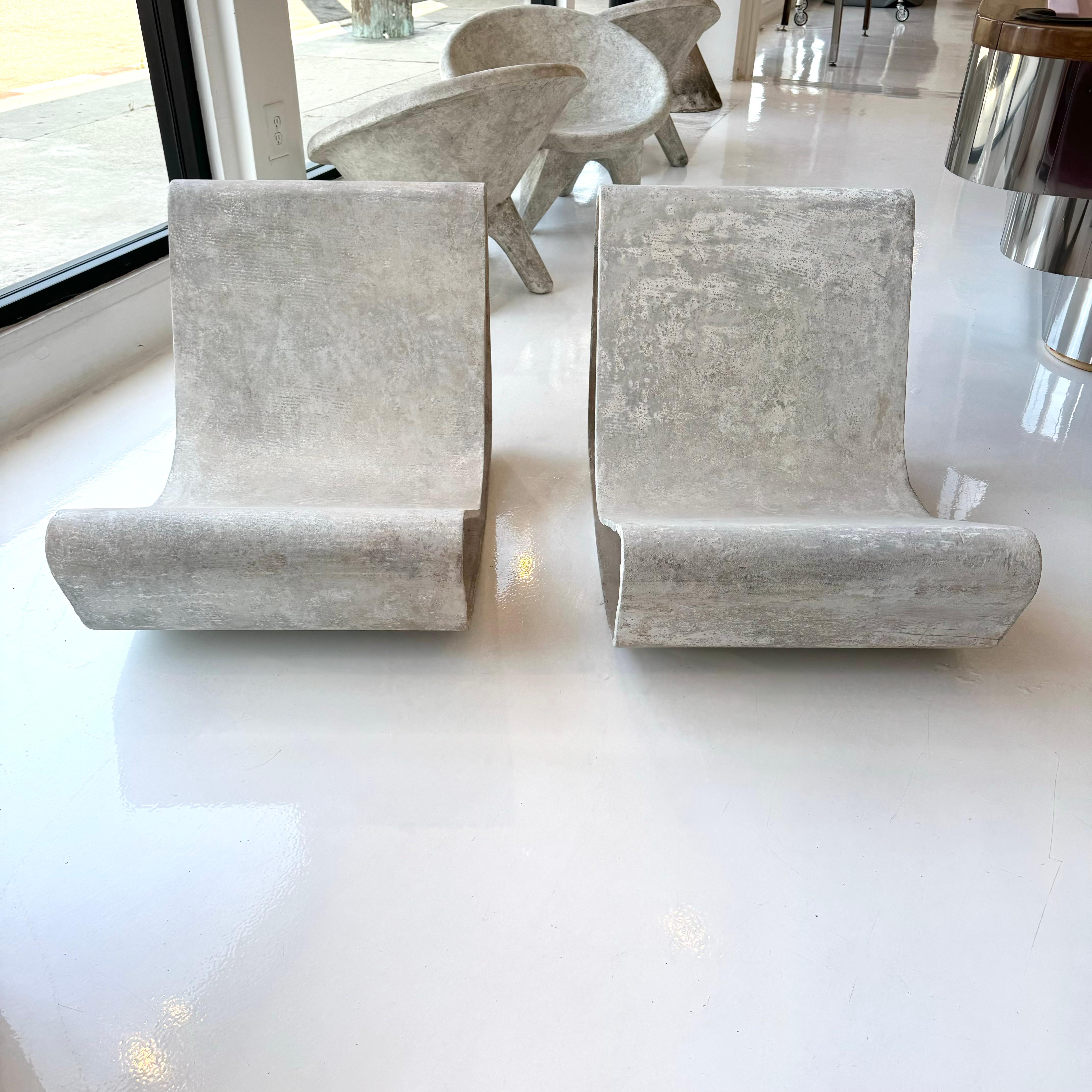 Iconic pair of concrete loop chairs by Willy Guhl. The loop chairs were designed by Willy Guhl in 1954. This pair is dated 11-2-1968 on the underside of the chair. Guhl watched as the Eternit fiber cement panels were fabricated with a machine at the