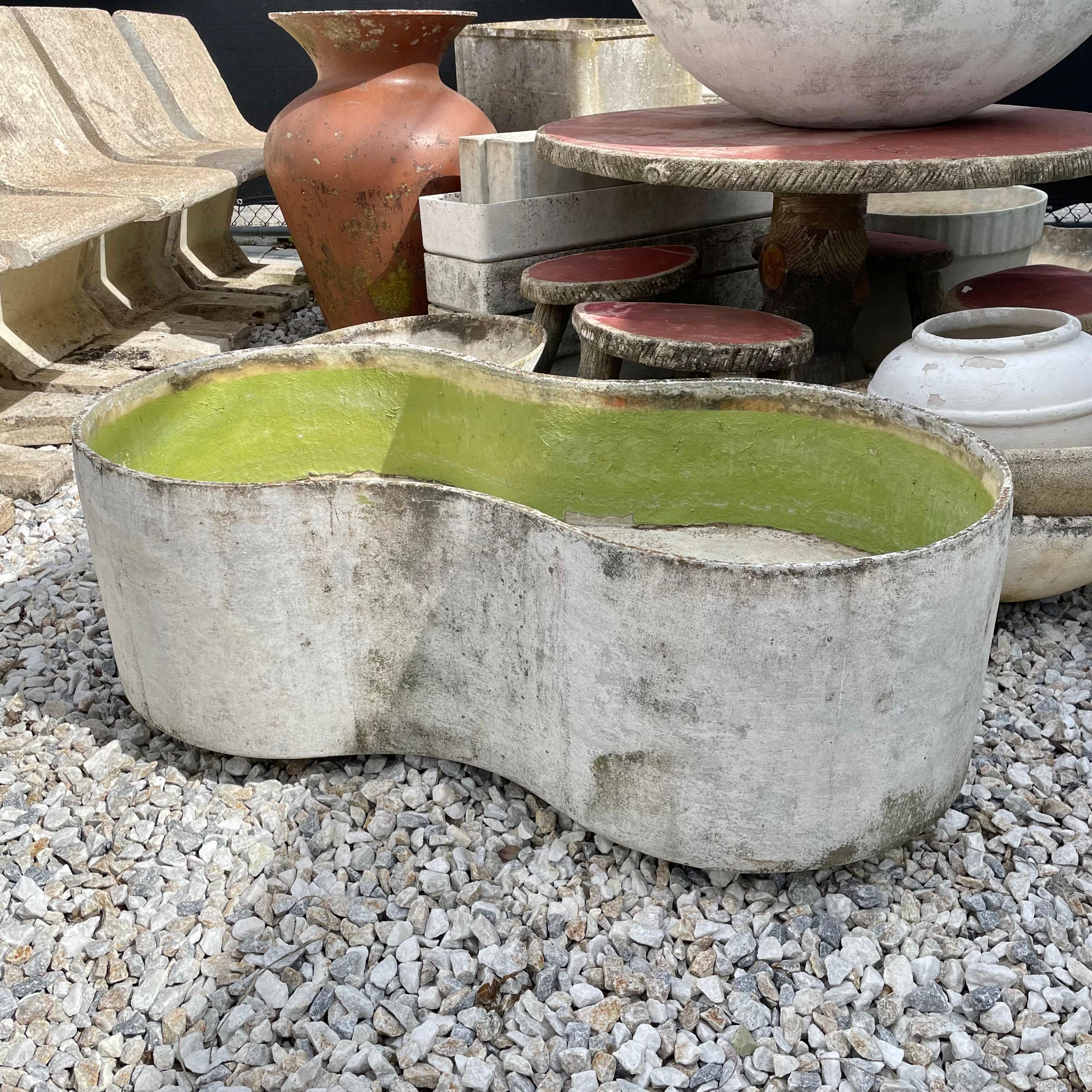 Monumental concrete basin planter by Willy Guhl. Handmade in Switzerland in the 1960s. Just under 4 feet in length. handmade in the shape of a peanut. Powerful presence and patina with a retro slime green interior making this piece eye catching and