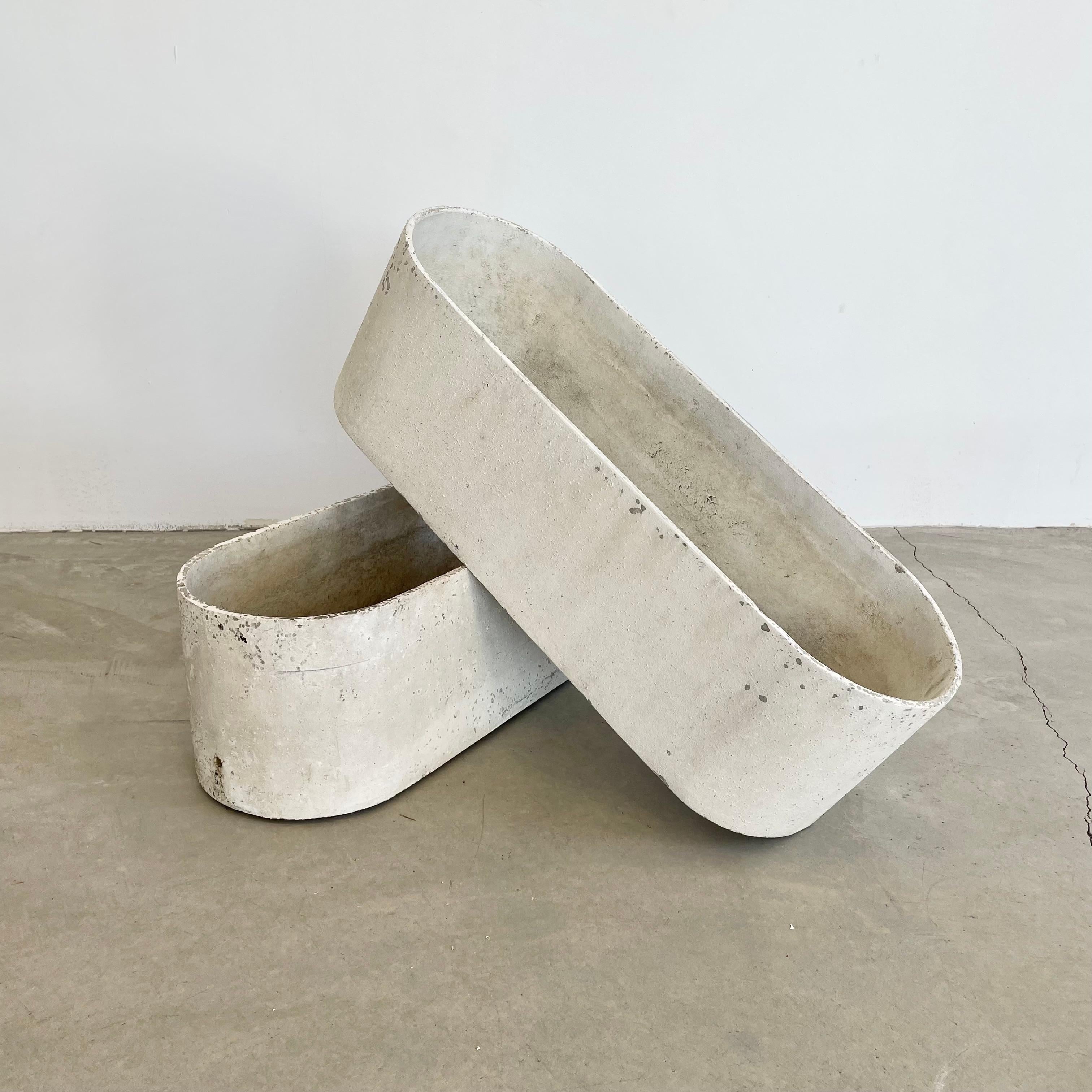 Pair of rare and unique pill shaped trough planters by Swiss architect and industrial design pioneer Willy Guhl for Eternit, Switzerland circa 1960s. Both painted white by previous owner. Factory drilled drainage holes on the ends of each planter.