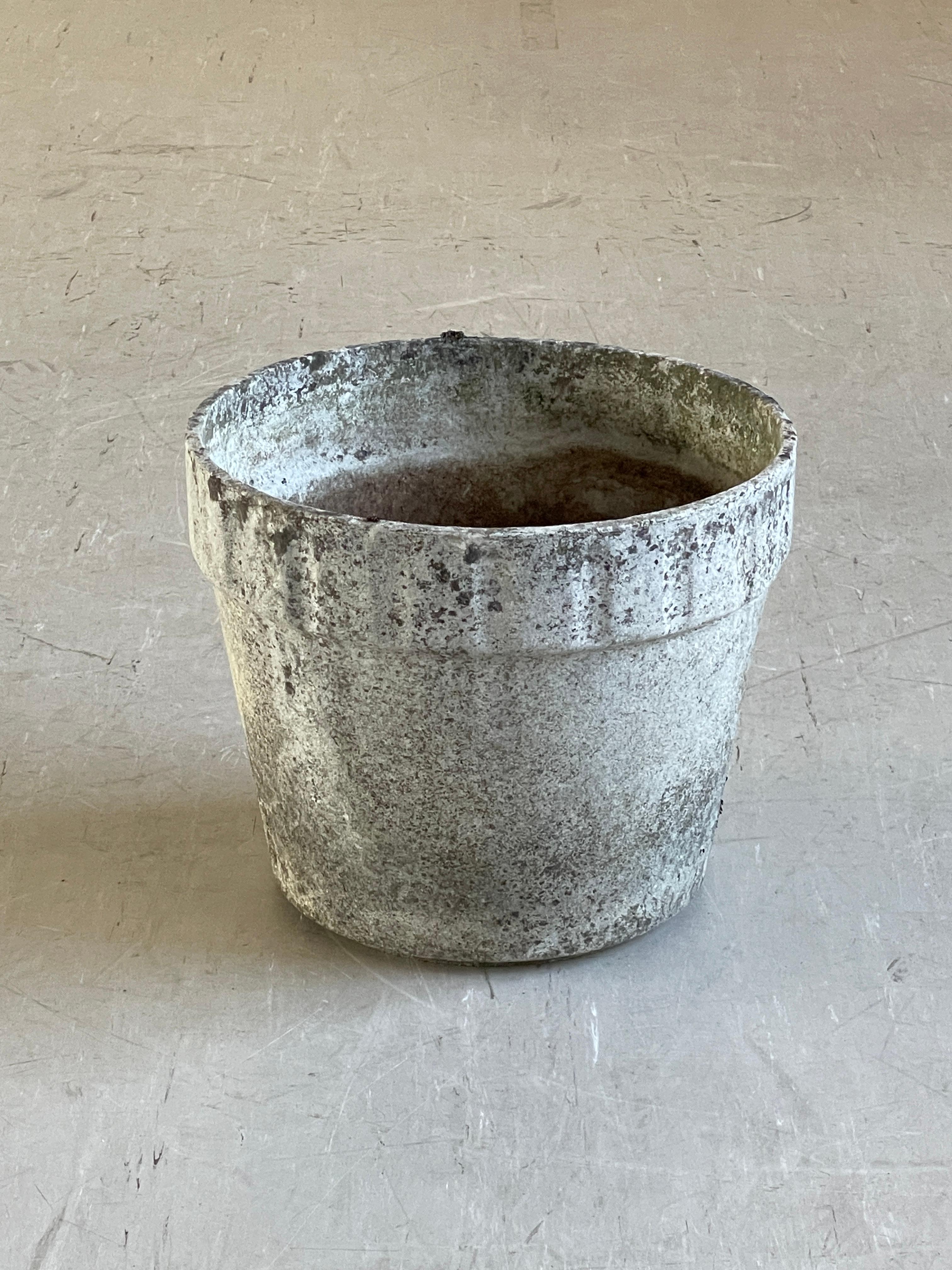 Monumental concrete flower pot by Swiss designer, Willy Guhl. Solid concrete made in Switzerland 1960 - 1970. Produced by Eternit AG.  Tapered structure with a ribbed upper section with factory drilled drainage holes. In original condition with