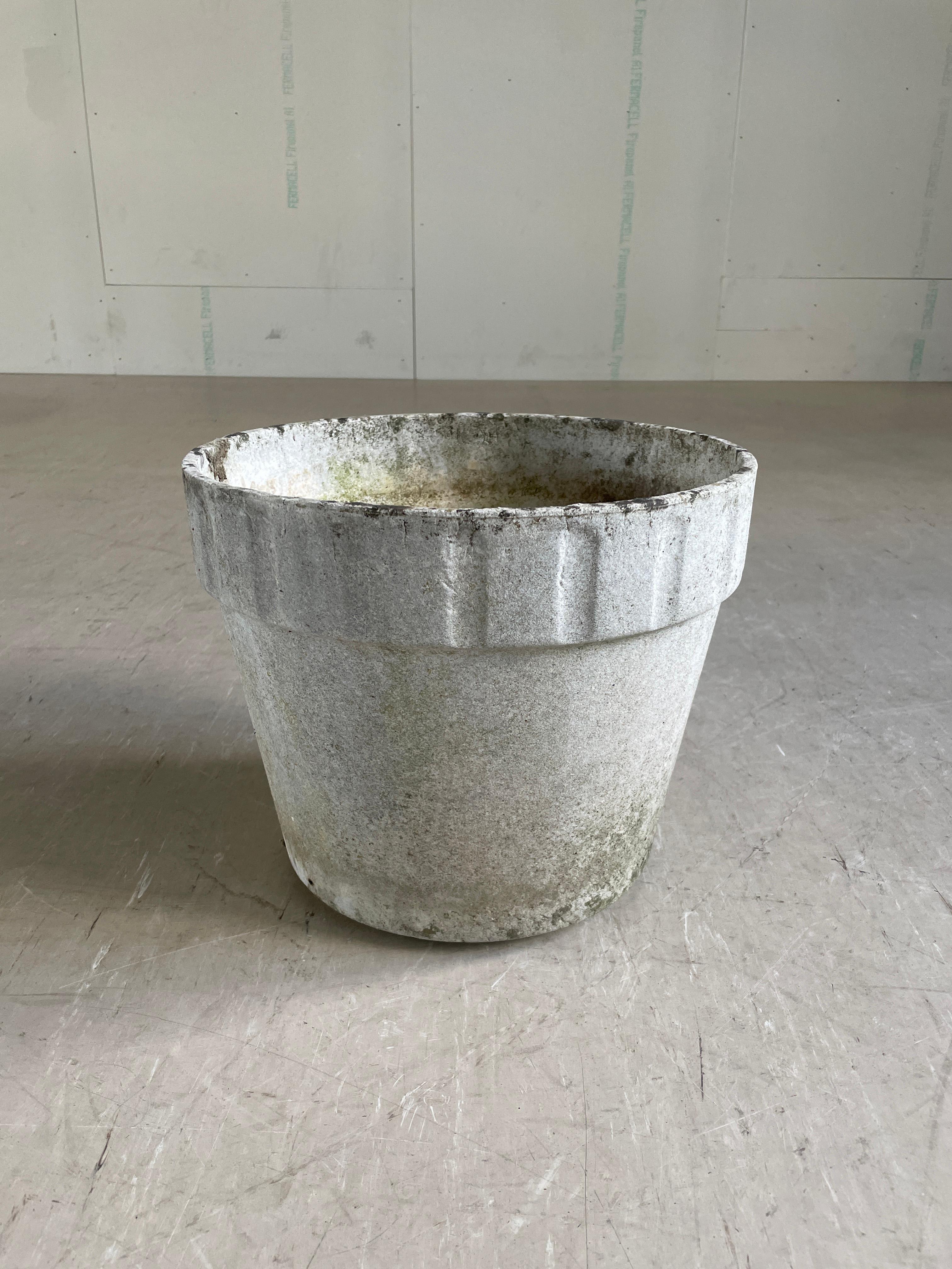 Monumental concrete flower pot by Swiss designer, Willy Guhl. Solid concrete made in Switzerland 1960 - 1970. Produced by Eternit AG.  Tapered structure with a ribbed upper section with drainage holes in base. In original condition with beautiful