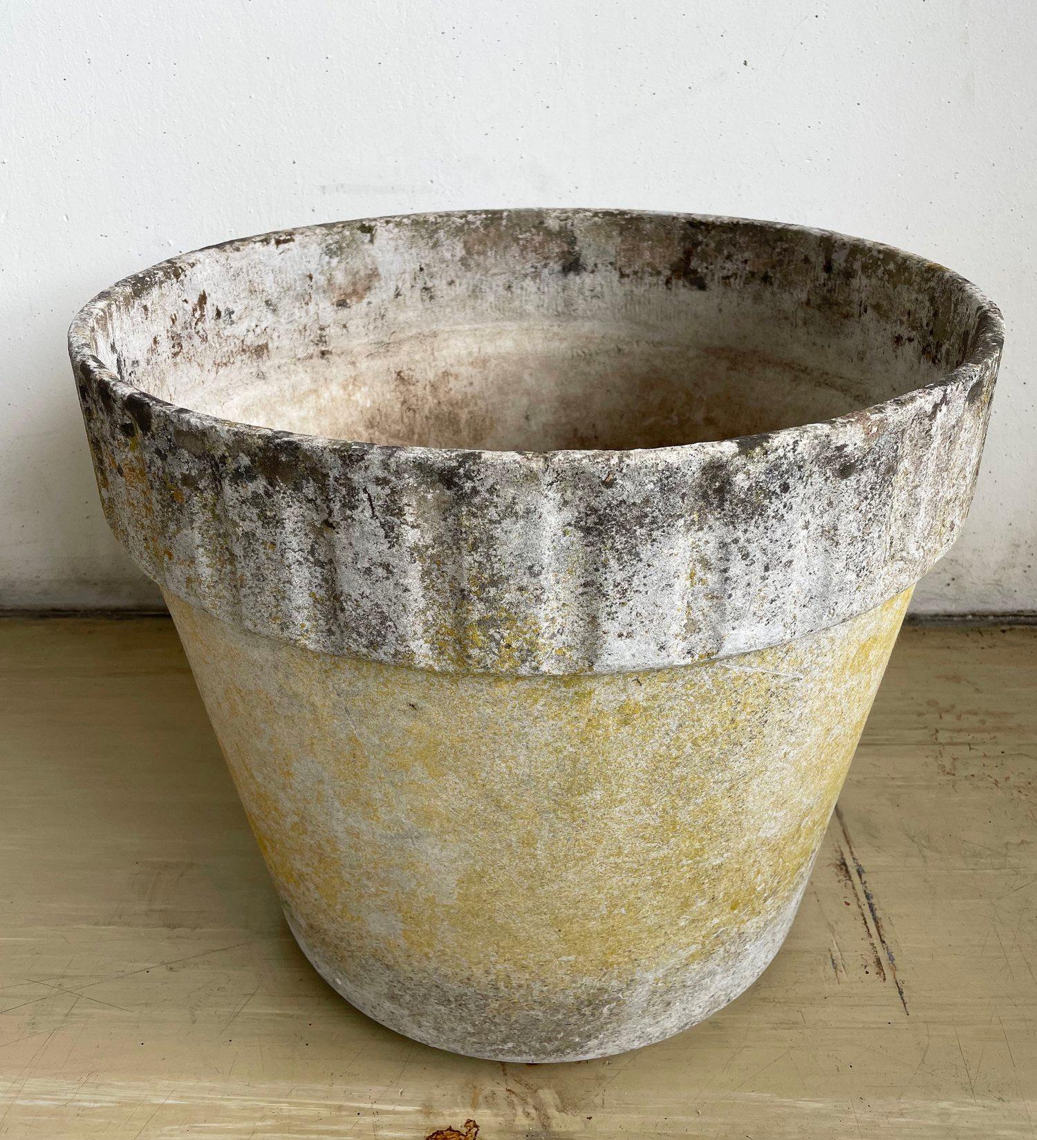 Monumental concrete flower pot by Swiss designer, Willy Guhl. Solid concrete made in Switzerland 1960 - 1970. Produced by Eternit AG.  
Tapered structure with a ribbed upper section with factory drilled drainage holes. In original condition with