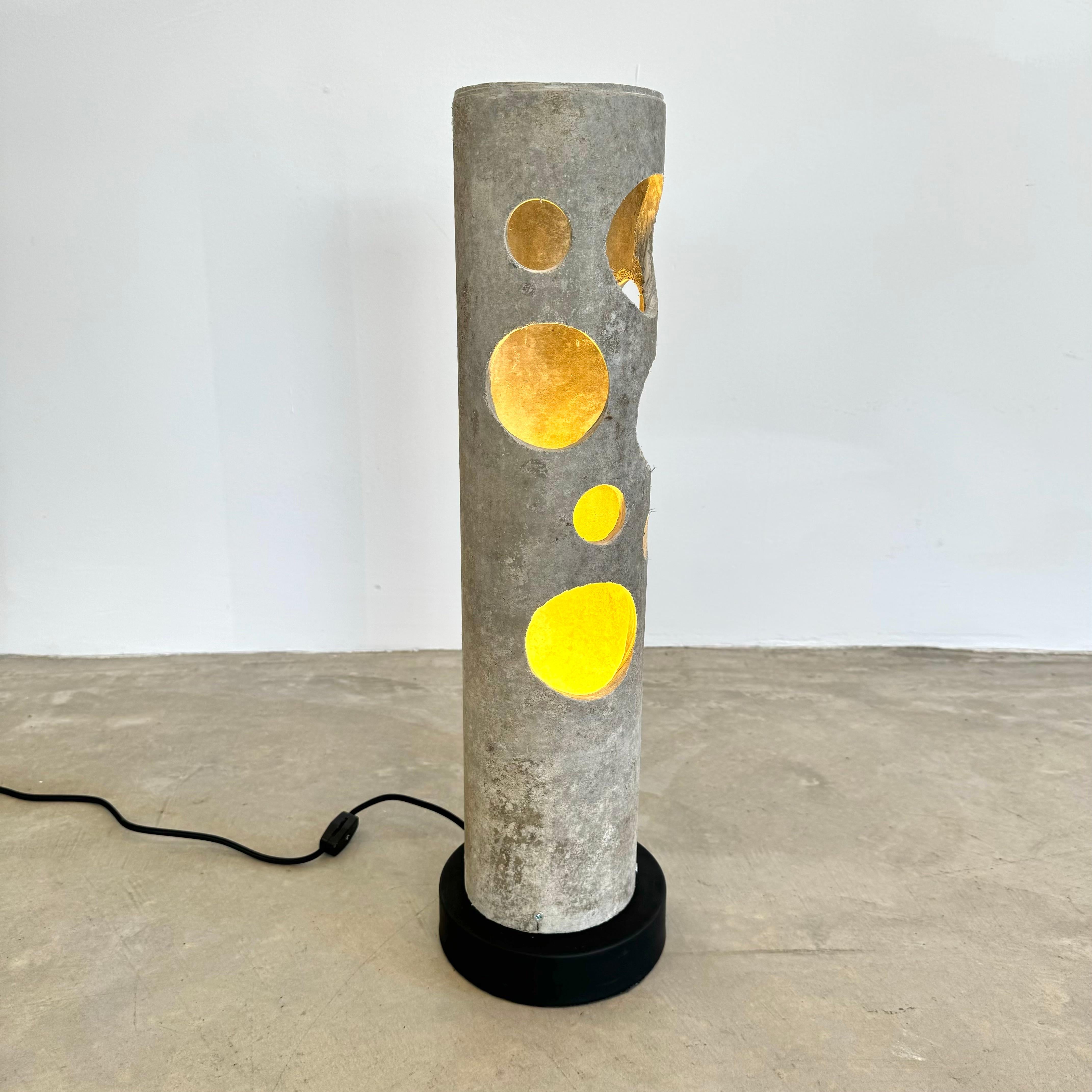 Fantastic rare concrete lamp by Willy Guhl for Eternit. Circular cutouts allow light through. One bulb inside each with on/off switch on the cord. Lovely soft grey color with subtle patina. Indelible presence. Mounted to a black pedestal. Great