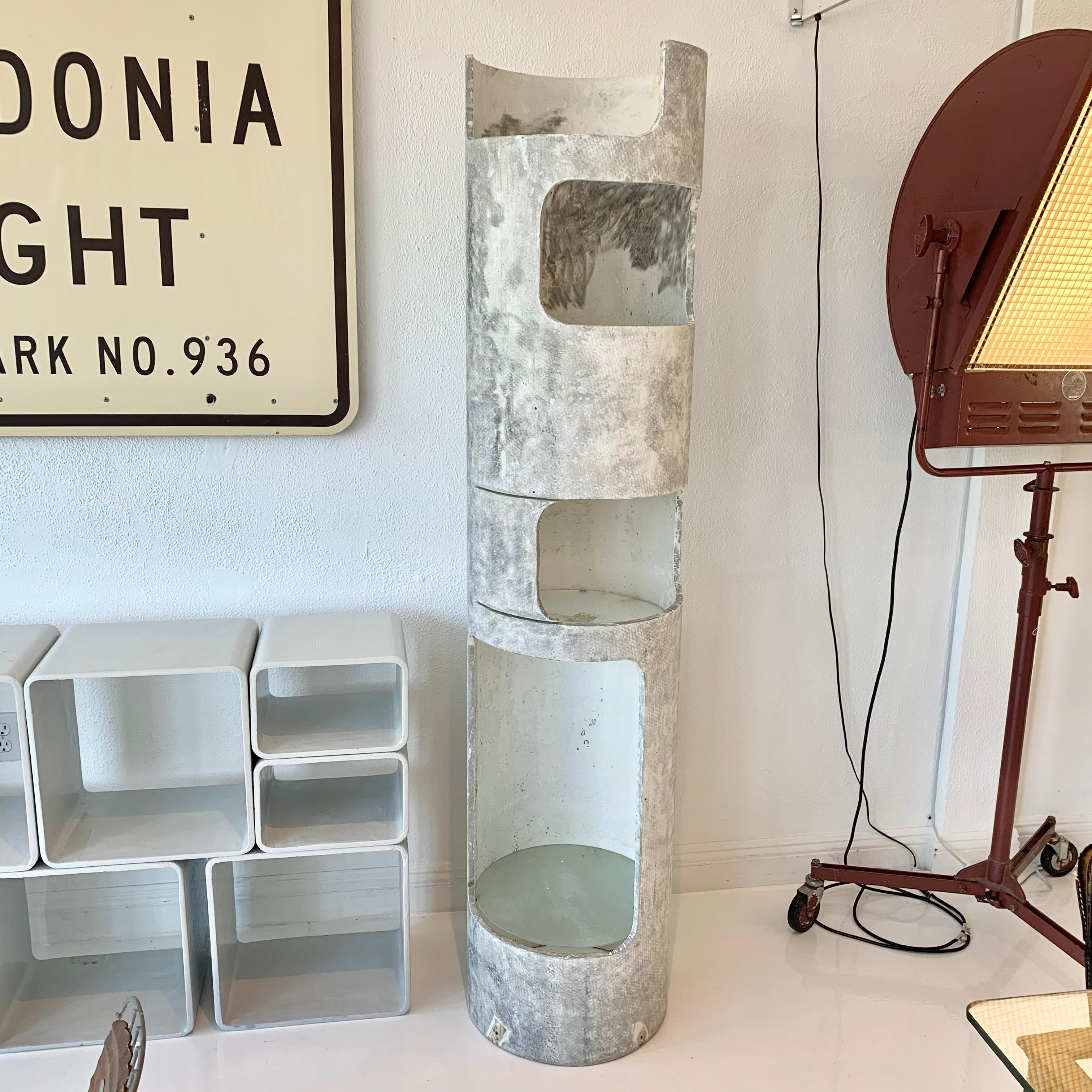 Interesting concrete tower by Willy Guhl for Eternit. Just over 6 feet tall. Concrete tower with 4 openings. Each opening holds a glass shelf. Great as a bookcase or plant stand, indoors or outside. Unusual piece. Two available in different patinas.
