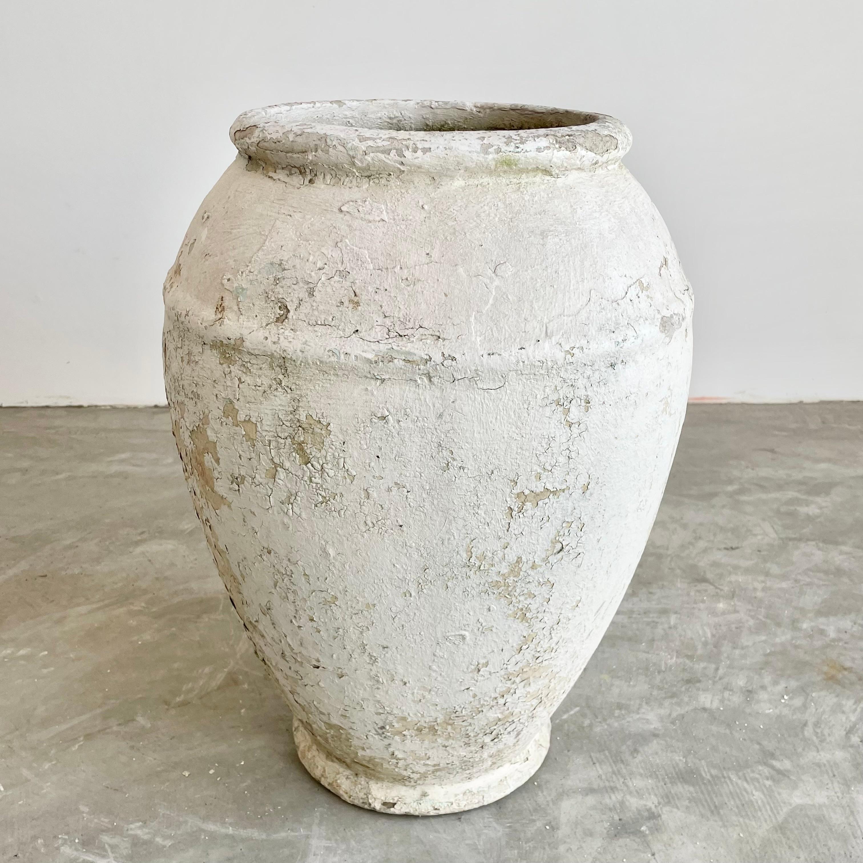 Concrete urn by Willy Guhl. Rare model. Excellent cream and grey patina. Urn has a delicate cement ridge around the mouth as well as around the widest part of the jar giving it depth and delicate lines. The body of the jar tapers down to the bottom