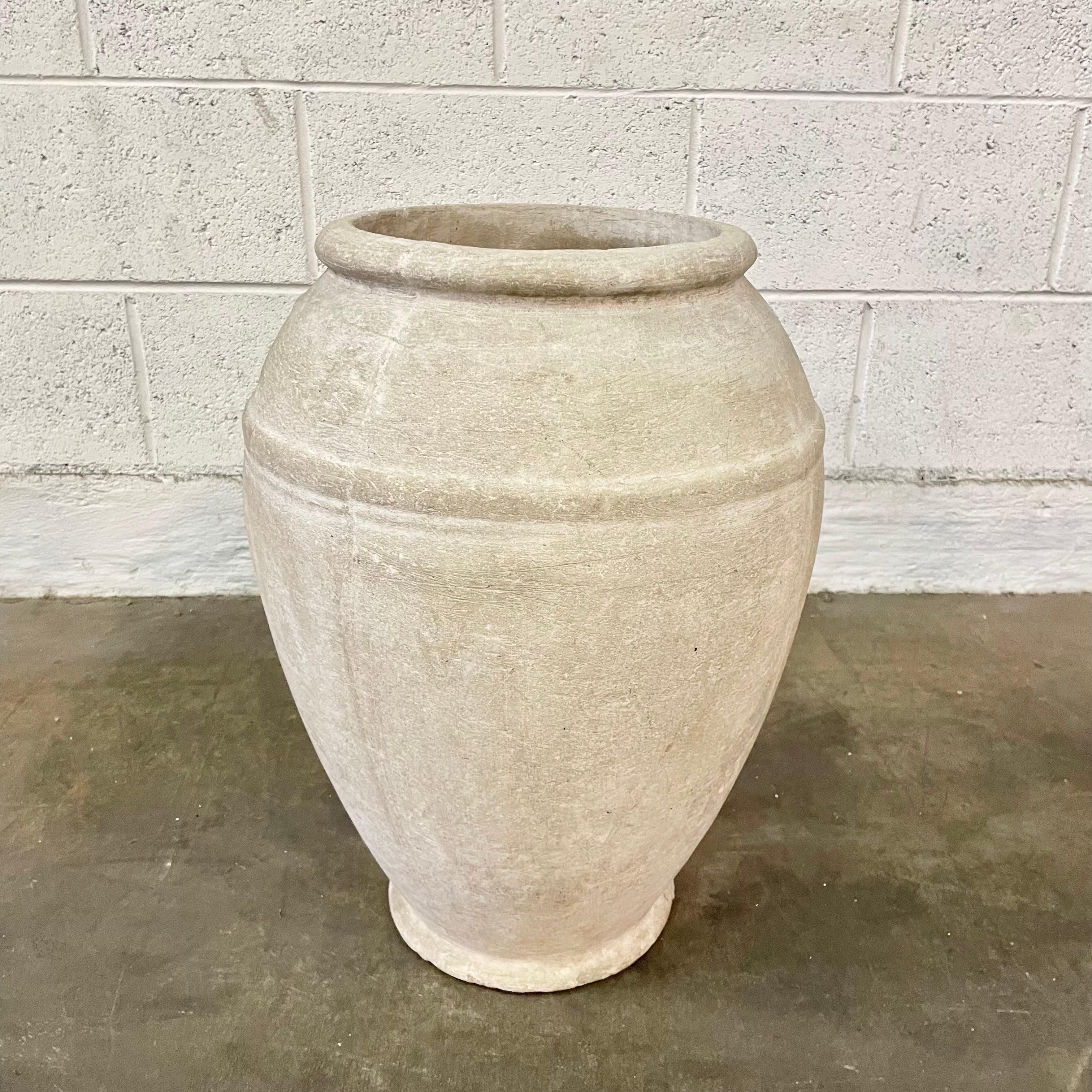 Concrete urn by Willy Guhl. Rare model. In original grey concrete patina. Urn has a delicate cement ridge around the mouth as well as around the widest part of the jar giving it depth and delicate lines. The body of the jar tapers down to the bottom