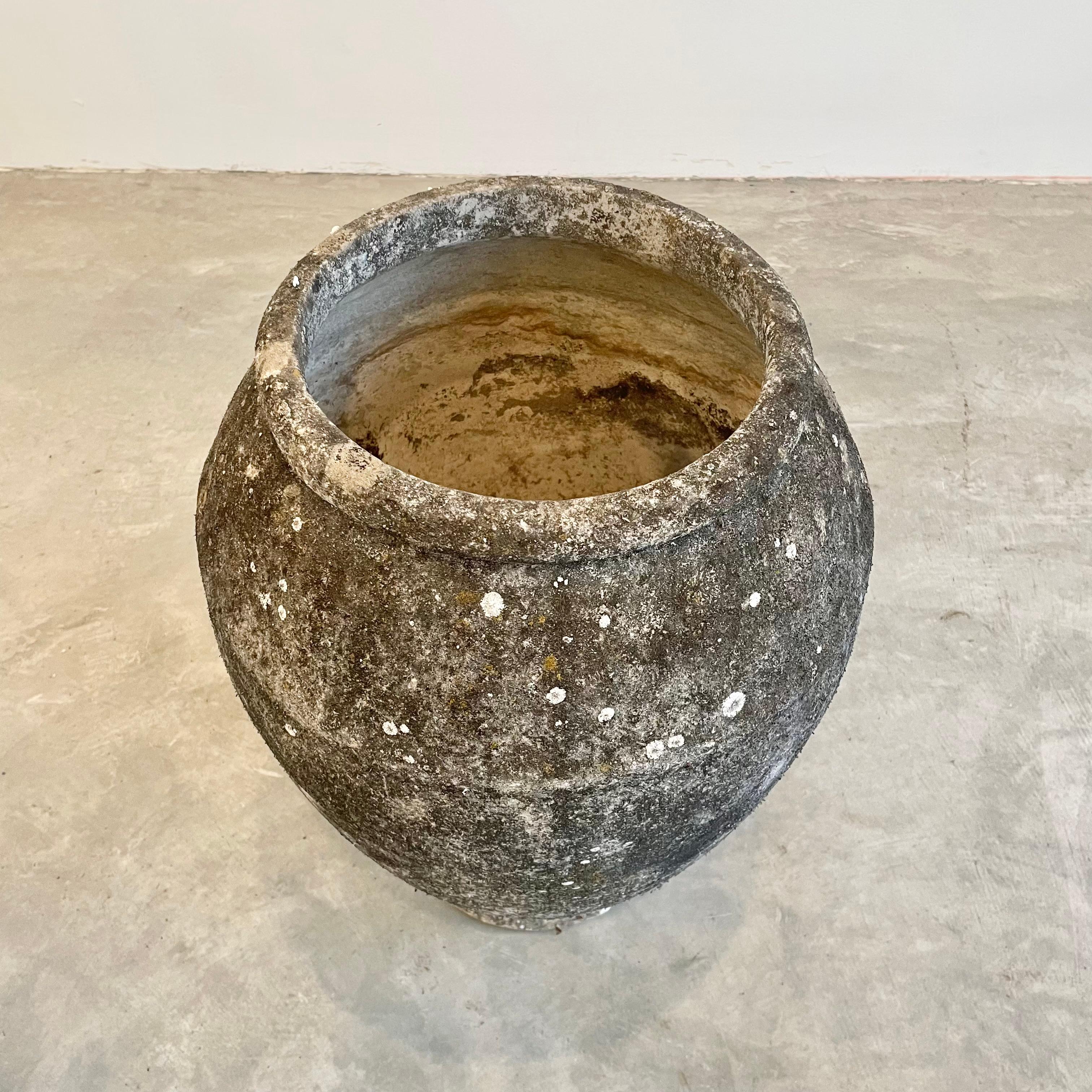 Concrete urn by Willy Guhl. Rare model. In a beautiful heavy patina from decades in Swiss weather. Urn has a delicate cement ridge around the mouth as well as around the widest part of the jar giving it depth and delicate lines. The body of the jar