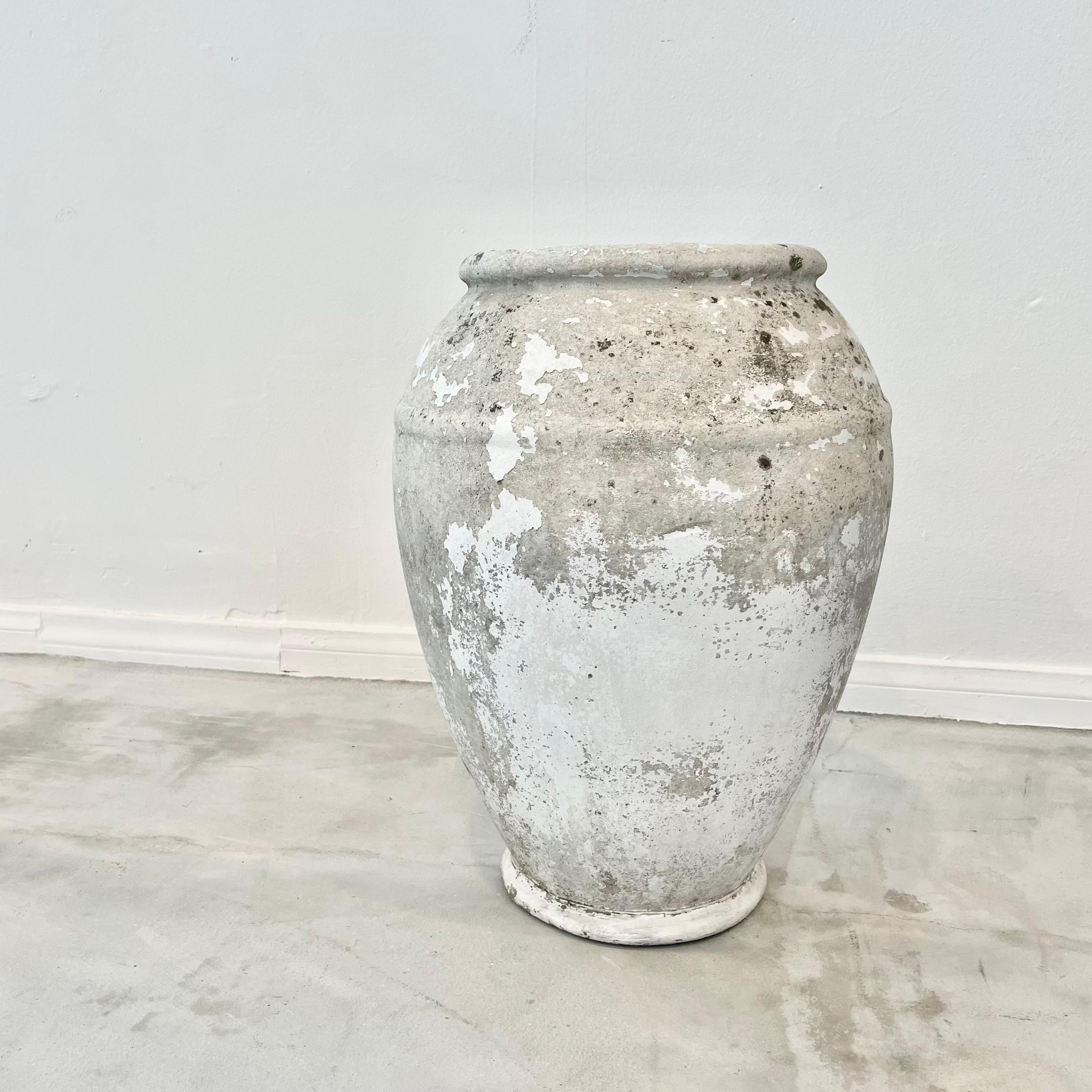 Concrete urn by Willy Guhl. Rare model. In a beautiful washed out patina from layers of white paint which have worn down over the years. Urn has a delicate cement ridge around the mouth as well as around the widest part of the jar giving it depth