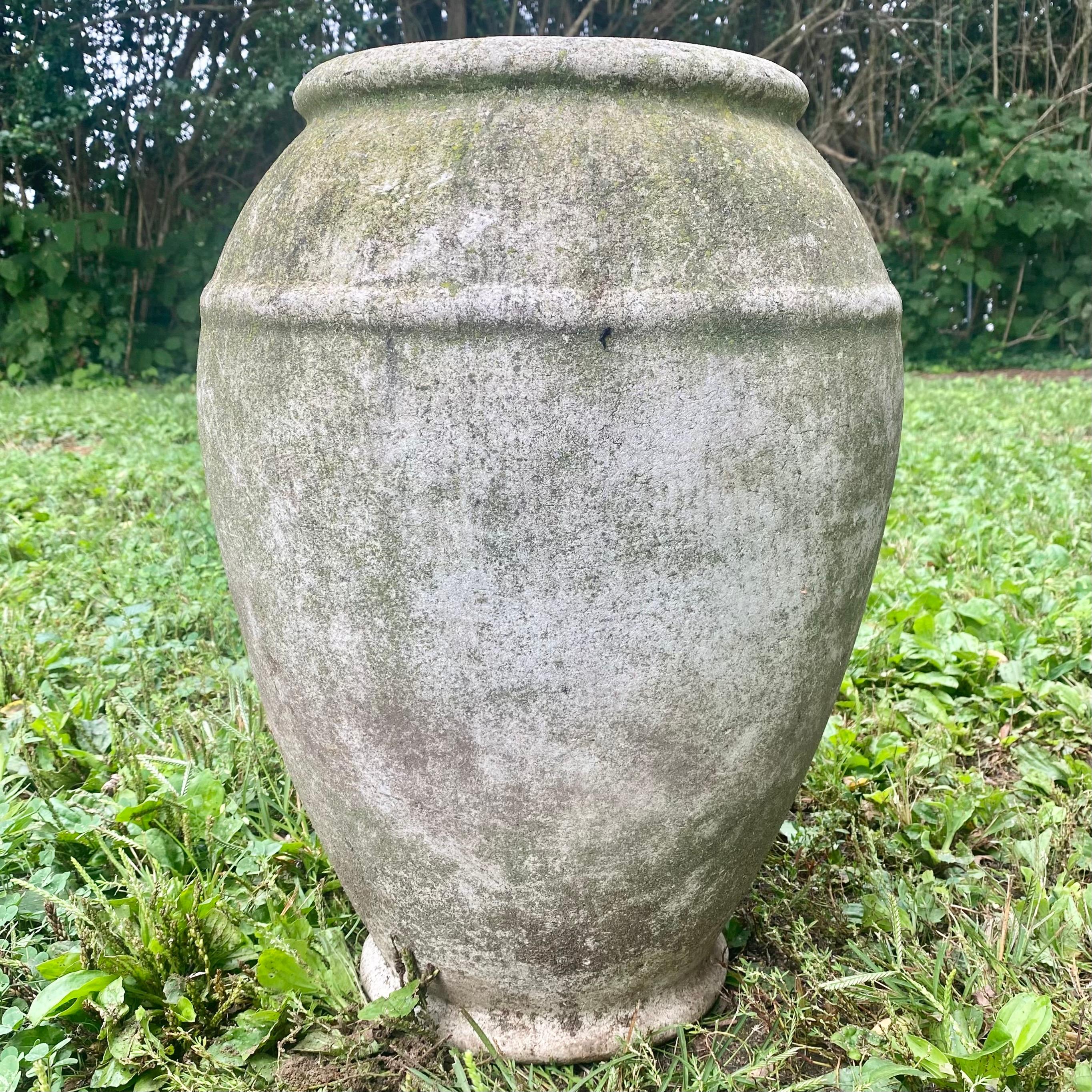 Concrete urns by Willy Guhl. Three available with varying degrees of patina and lichen. Rare model. Urns have a delicate cement ridge around the mouth as well as around the widest part of the jar giving it depth and delicate lines. The body of the