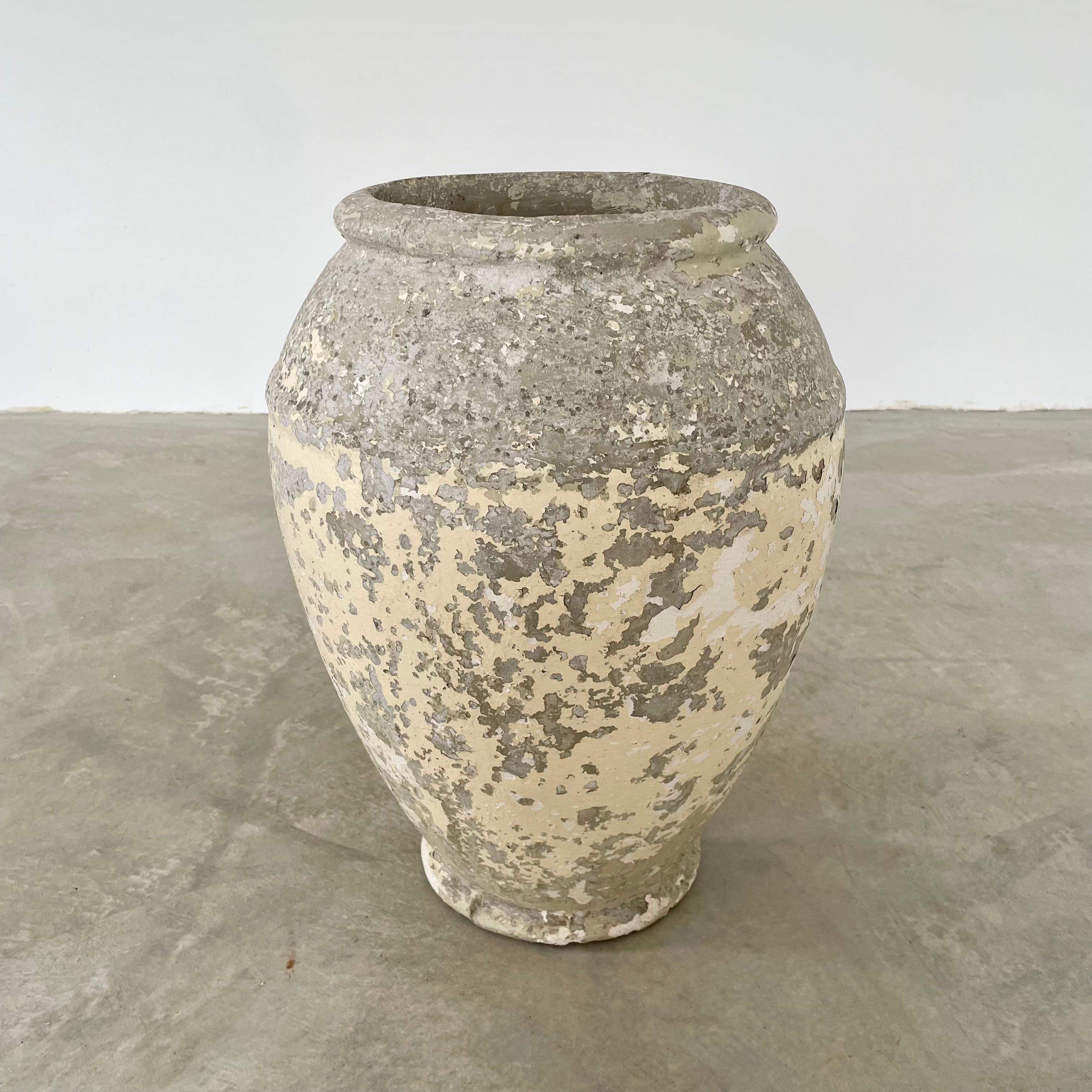 Concrete urn by Willy Guhl. Rare model. Excellent pastel yellow and grey patina. Urn has a delicate cement ridge around the mouth as well as around the widest part of the jar giving it depth and delicate lines. The body of the jar tapers down to the