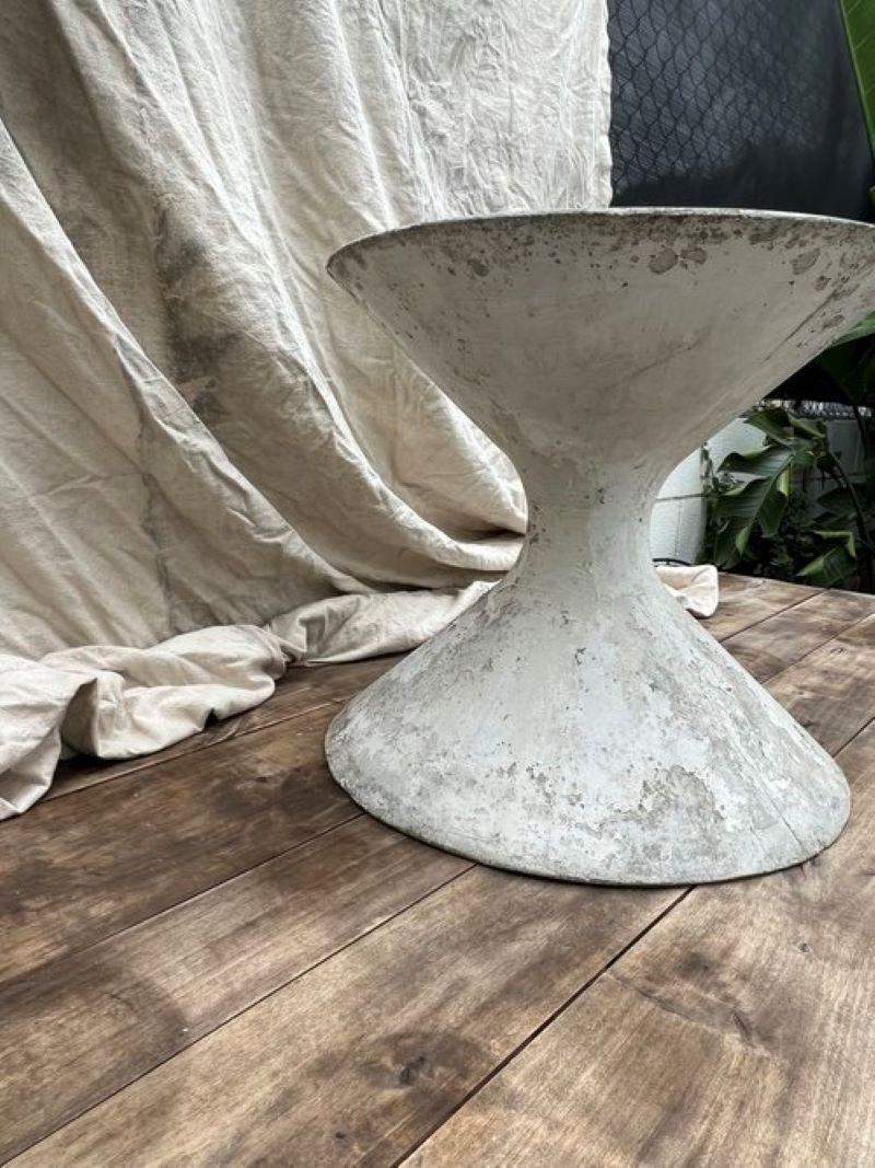 Discover the willy guhl hourglass planter – a medium-sized masterpiece by swiss architect willy guhl. Standing 19” inches tall with an 18-inch diameter, its eye-catching hourglass shape adds sculptural flair to any garden. Crafted from durable