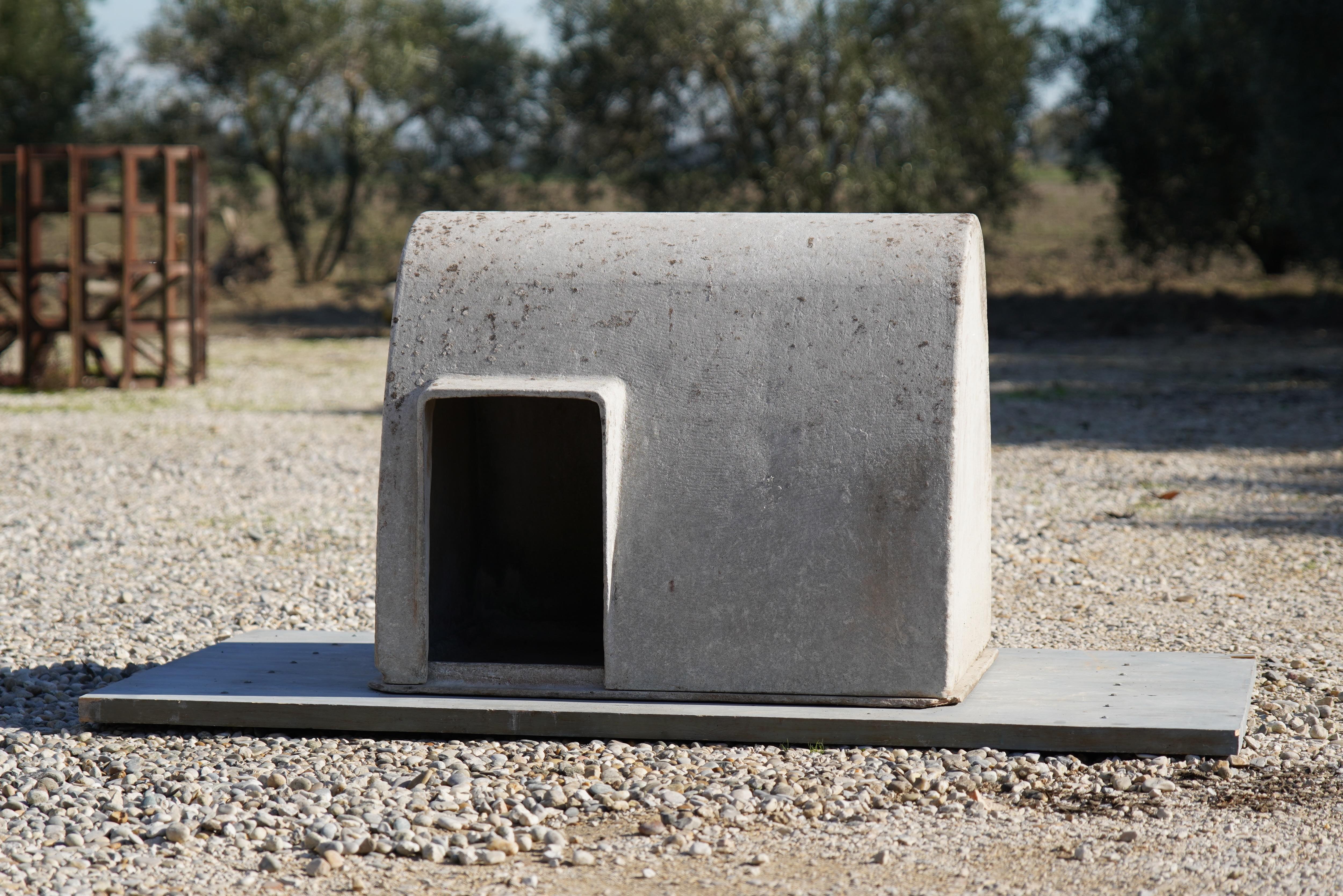 Designed by the iconic Willy Guhl in the 1960s and made of strong and lightweight fiber cement by Eternit, SA of Switzerland, this dog house with its original removable pan is as unique as it is beautiful. 

It's in excellent condition (as seen in