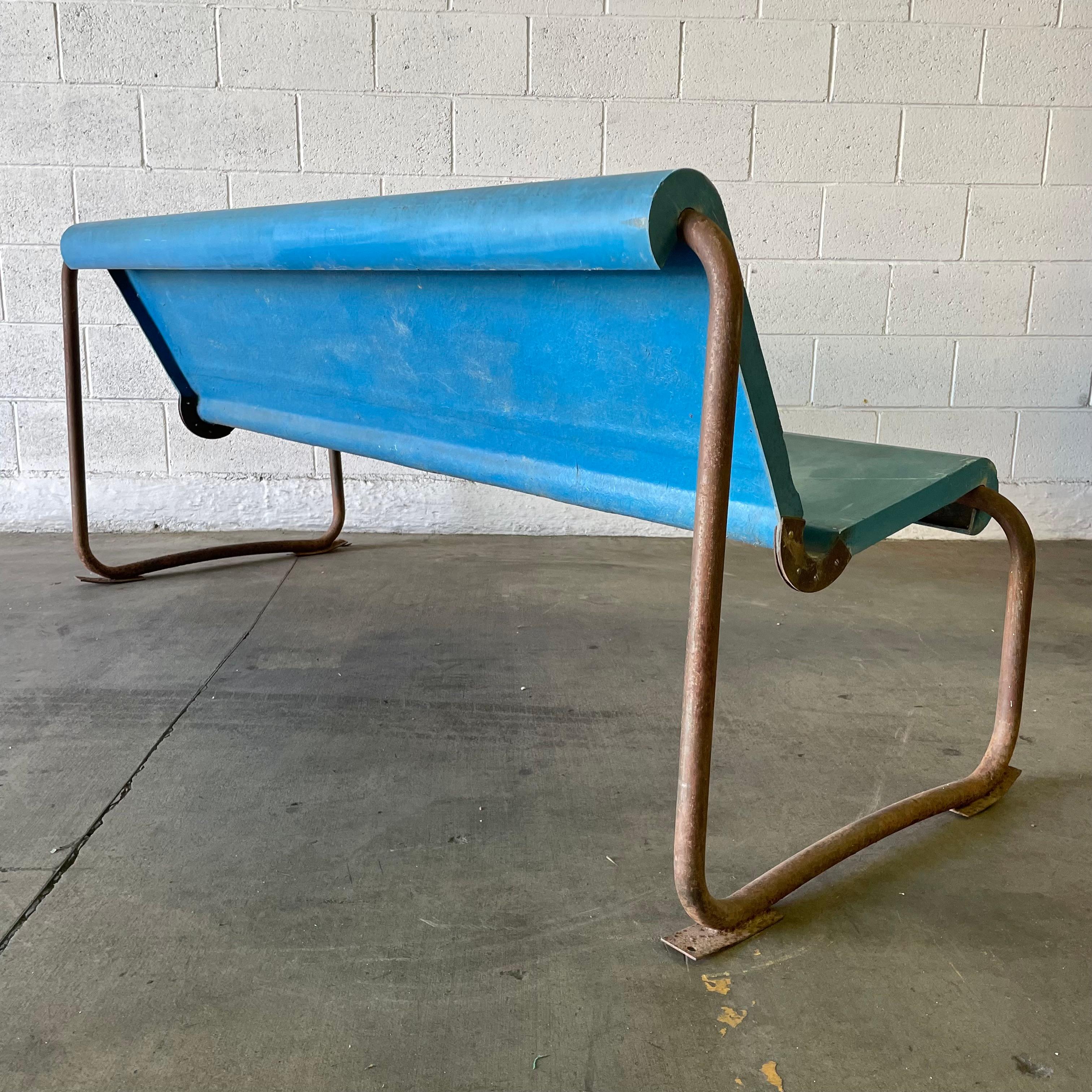 A remarkable midcentury floating bench by Swiss Architect Willy Guhl. Circa 1960s. Perfect minimal design as is common with the Swiss designer. The pastel blue seat is made of fiberglass and is suspended by a tubular metal frame. Incredible patina