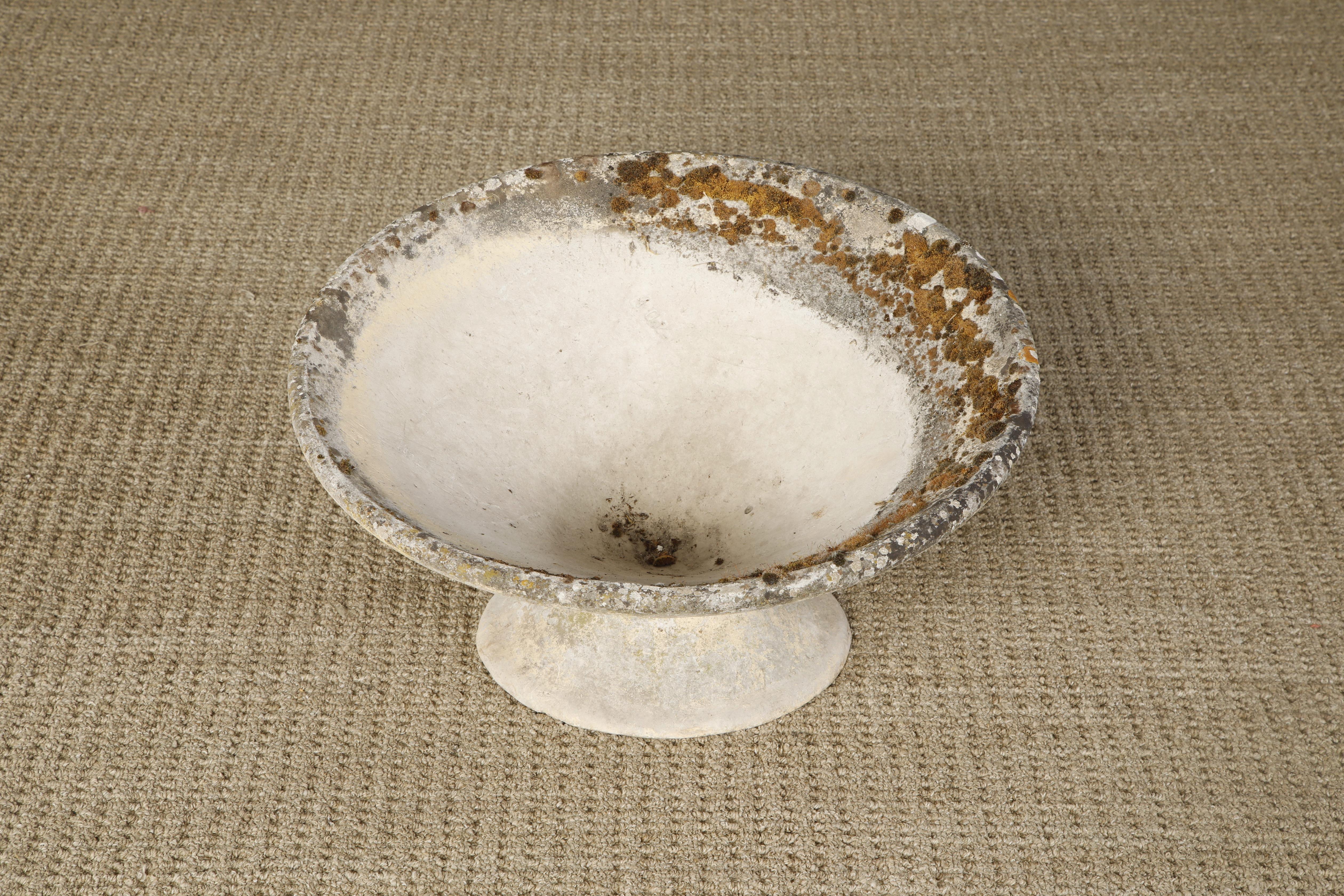 A beautiful tilted spindle concrete planter by Swiss architect Willy Guhl for Eternit, circa 1968, Switzerland. This special 'tilted' hourglass shaped concrete spindel planter has a patinated natural finish including fine moss and lichens. Excellent