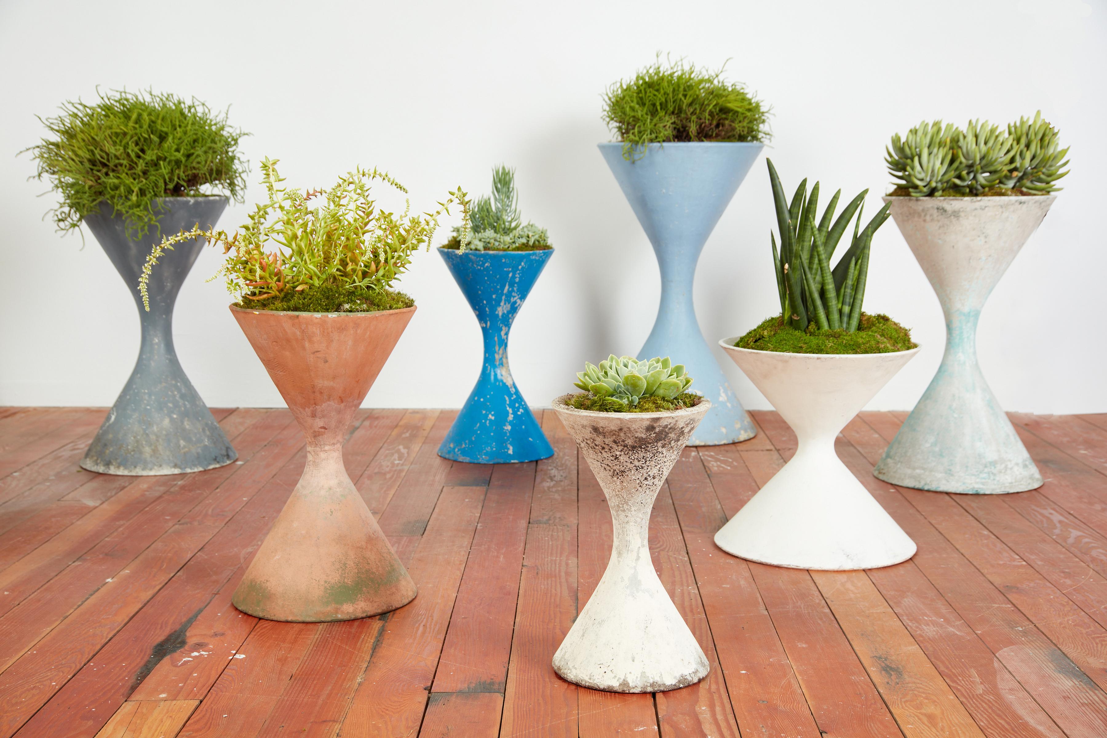 Wonderful collection of concrete hourglass planters by the Swiss Architect, Willy Guhl. Great age, patina and coloring. Iconic sculptural planter or garden object. This listing is for a 35.5