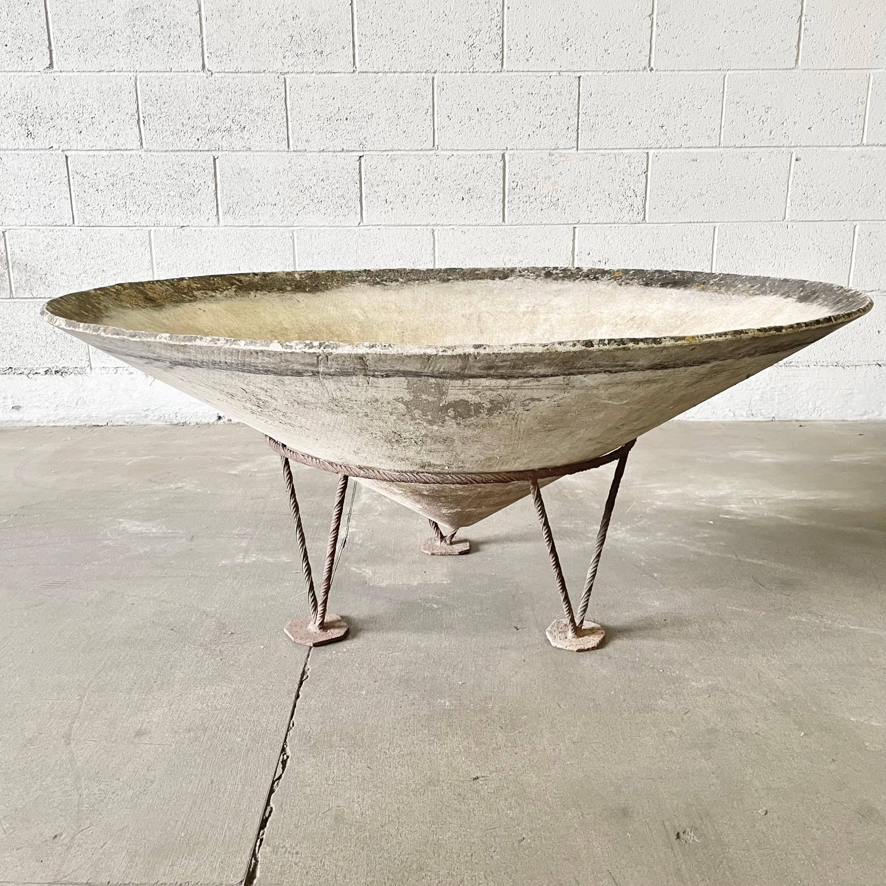 Monumental Willy Guhl cone planter with twisted iron base. Three triangular legs that each come to a point give this base a unique tripod design. Cone floats slightly off the ground once in the base. Beautiful patina to planter and base. Removable