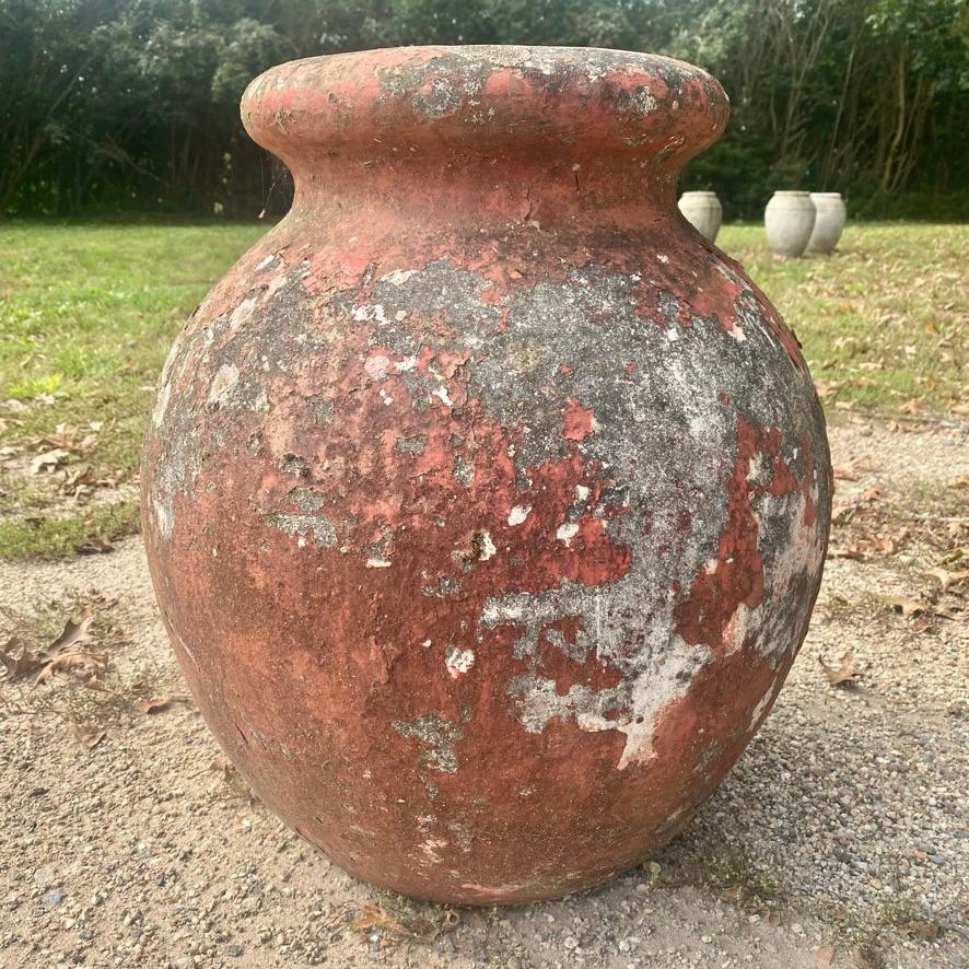 Concrete olive jar planter by Willy Guhl in a beautiful brick red color. Simple and elegant design perfect for any garden or patio. Excellent patina and vintage condition. Manufacture number stamped on inside of lip. Olive jars in this size and in a