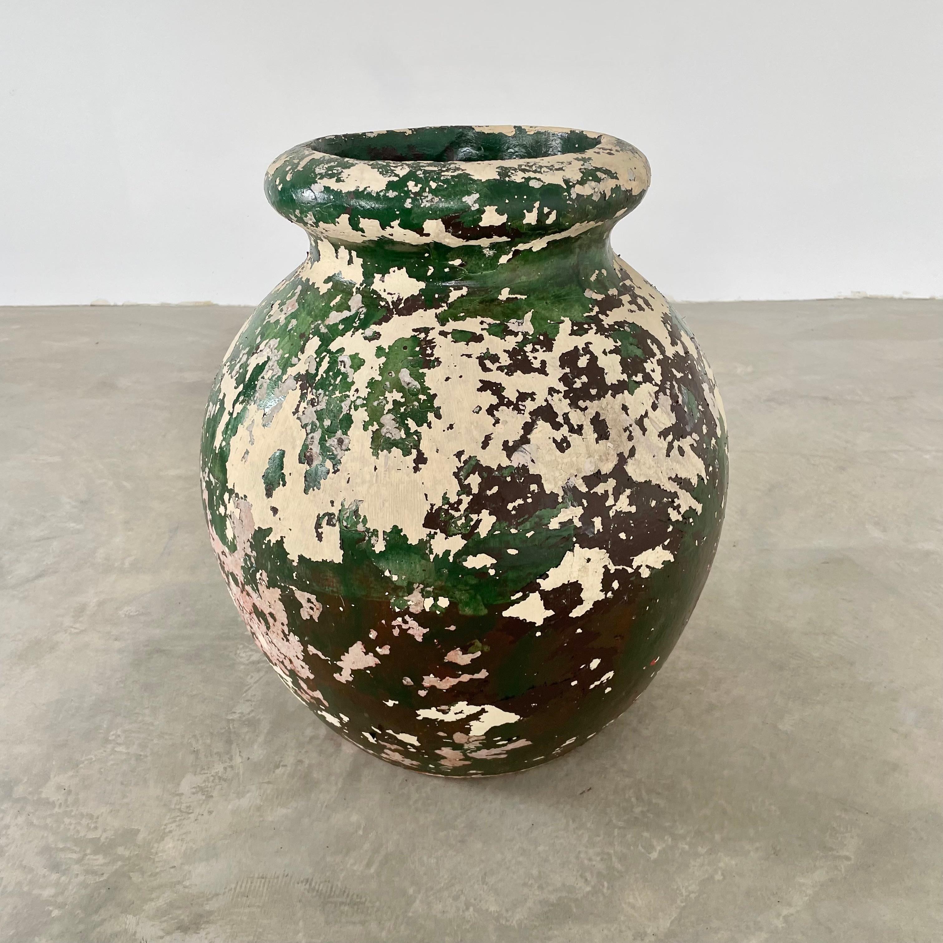 Stunning concrete olive jar planter by Willy Guhl with great patina and coloring. Amazing depth to the piece due to the layers of yellow, green and brownish red hues. Simple and elegant design perfect for any garden or patio. Small drainage hole on