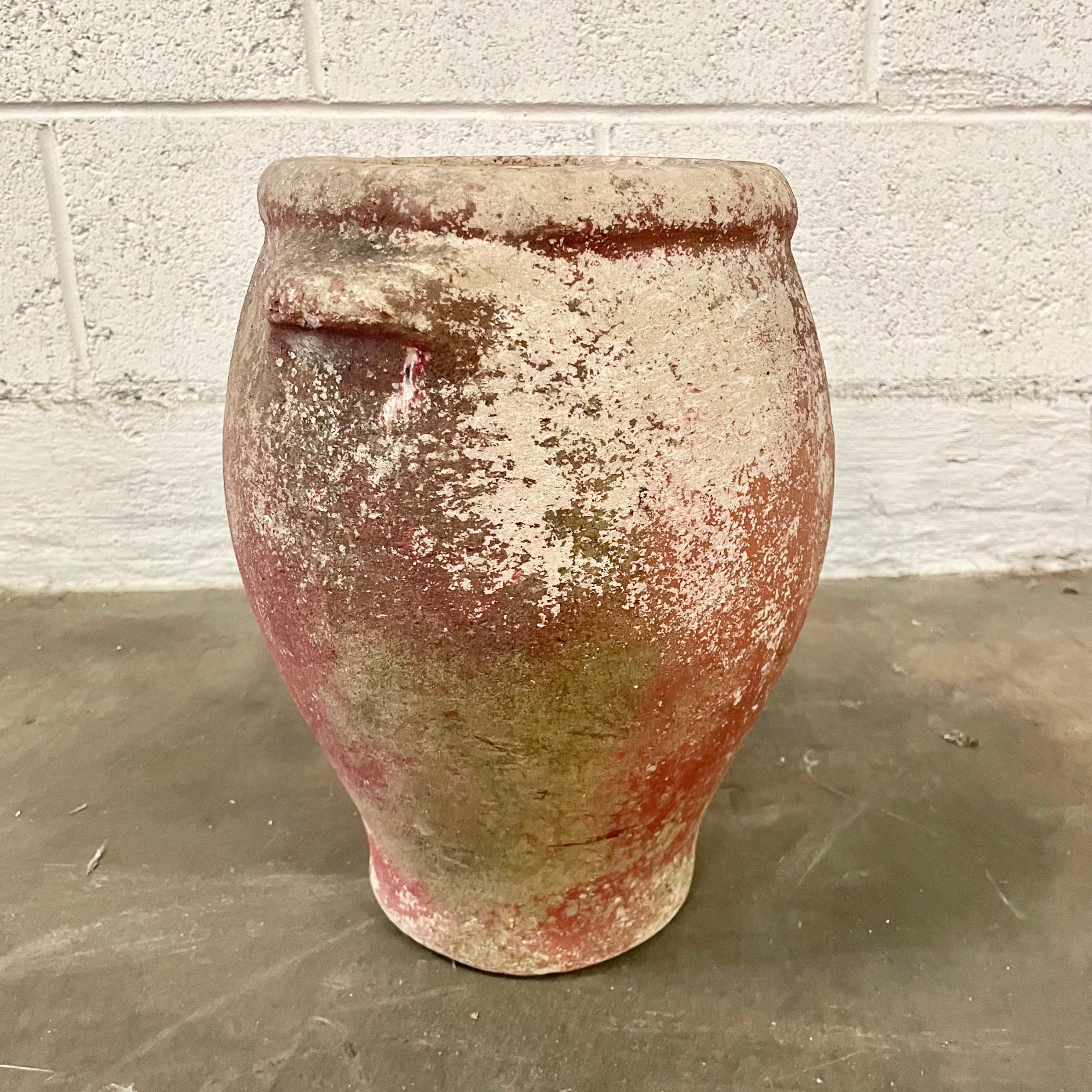 Petite concrete urn by Willy Guhl in a beautiful red patina. Urn has a delicate cement ridge around the mouth and two handles right under the upper rim. The body of the jar tapers down to the bottom. Great vintage condition. Only one available.