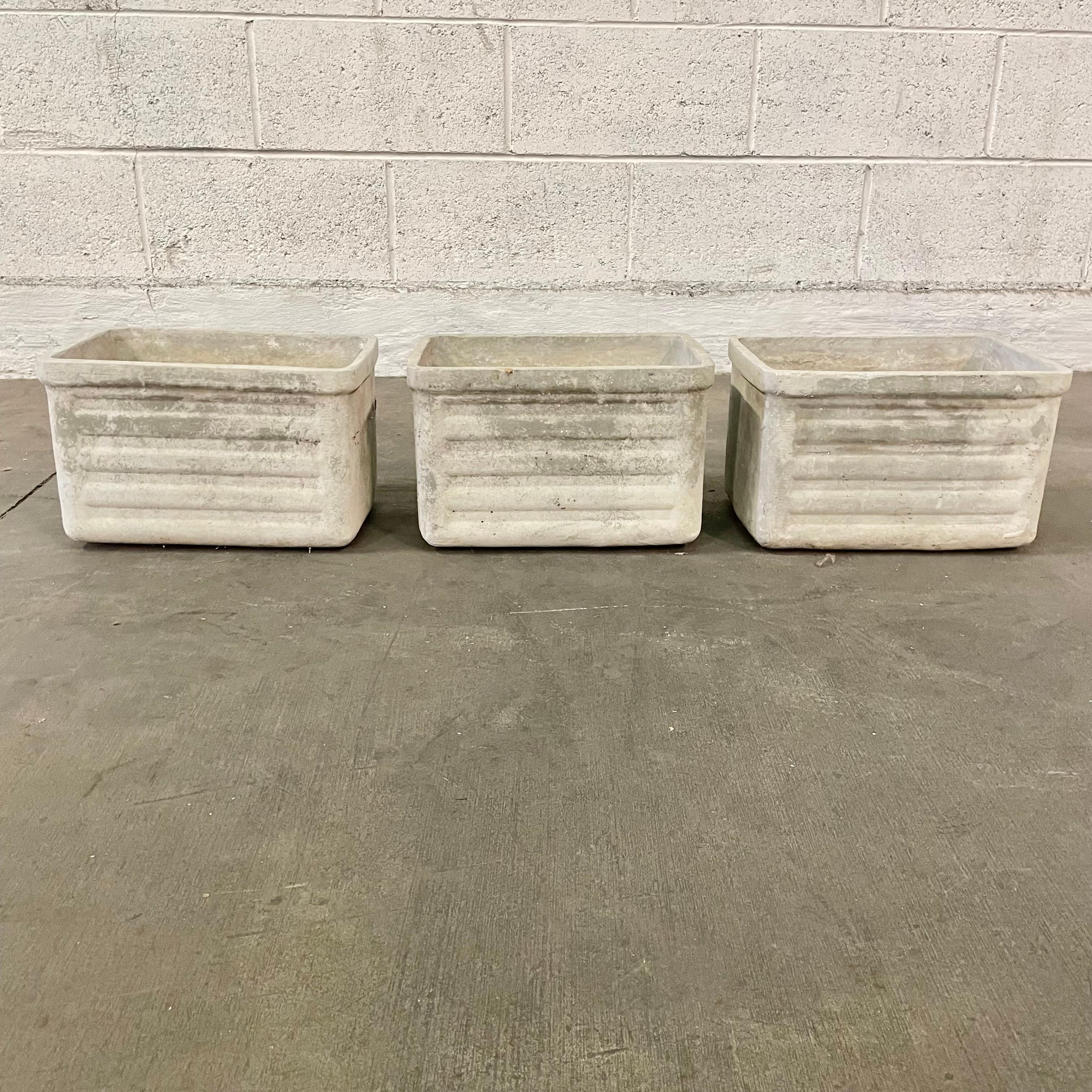 Petite ridged planters by Willy Guhl. Concrete planters in the shape of a rectangle with an upper rim and ridged sides. Great scale. Very good condition with similar patina on all 3 available. Priced individually. 

