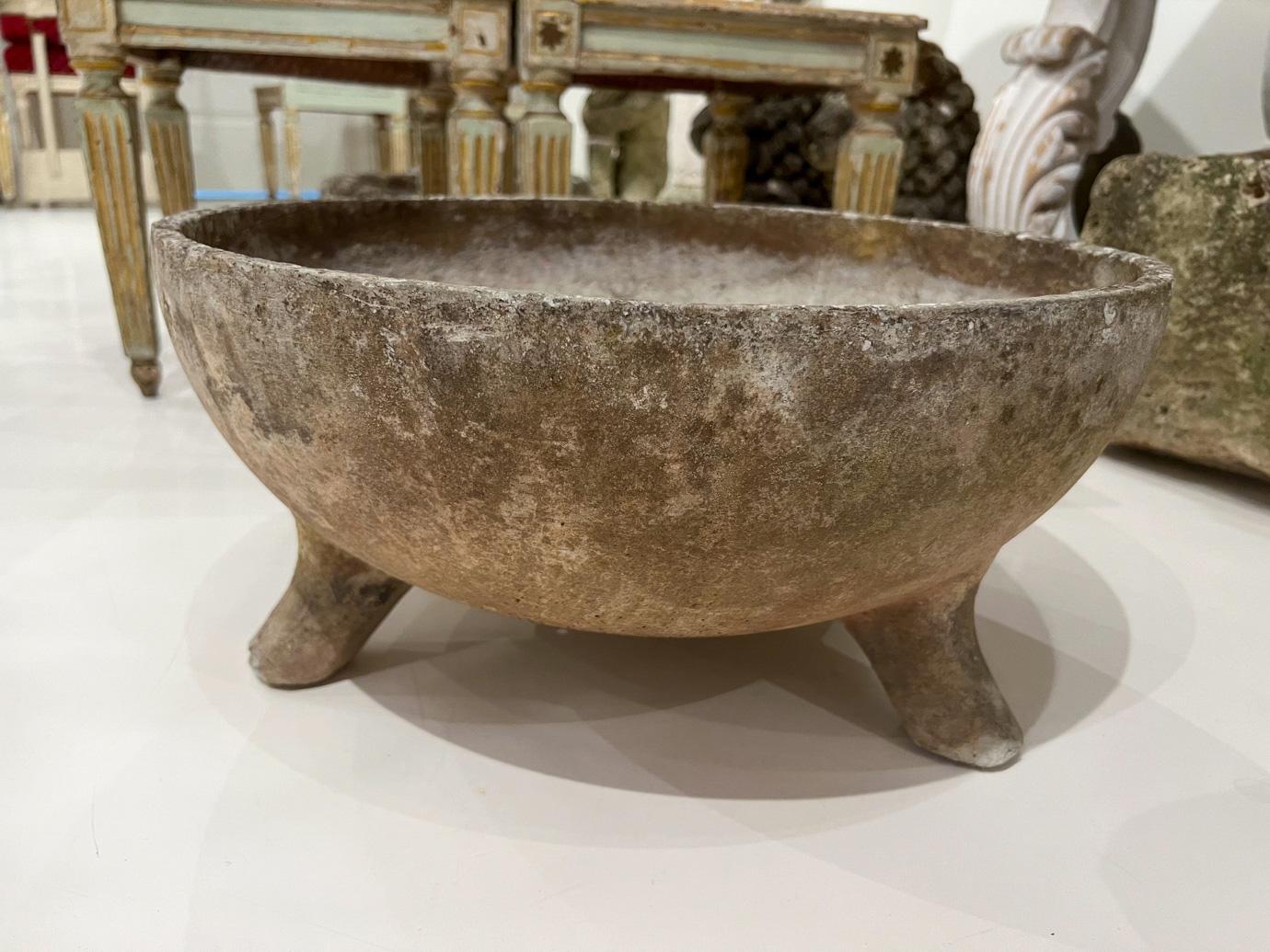 Willy Guhl was a famous Swiss designer who created planters in many shapes. These are formed from a slab of Eternit (a fibrous concrete material) moulded into a bowl with feet. 
   