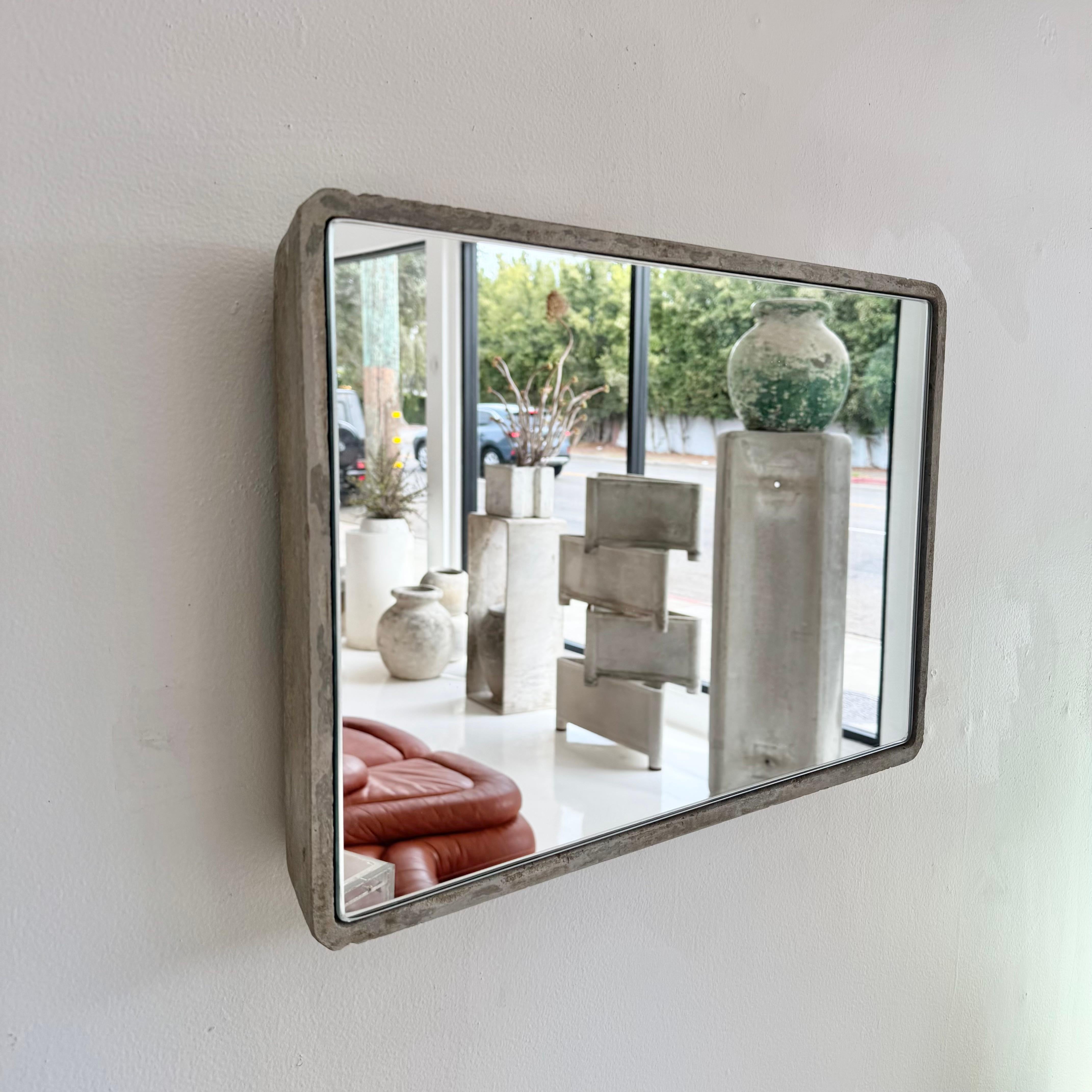 Gorgeous rectangular Willy Guhl concrete mirror. Concrete vessel originally produced at the Eternit factory in Switzerland in the 1960’s. Custom glass/mirror was professionally hand cut and added recently. Beautiful patina as expected with age