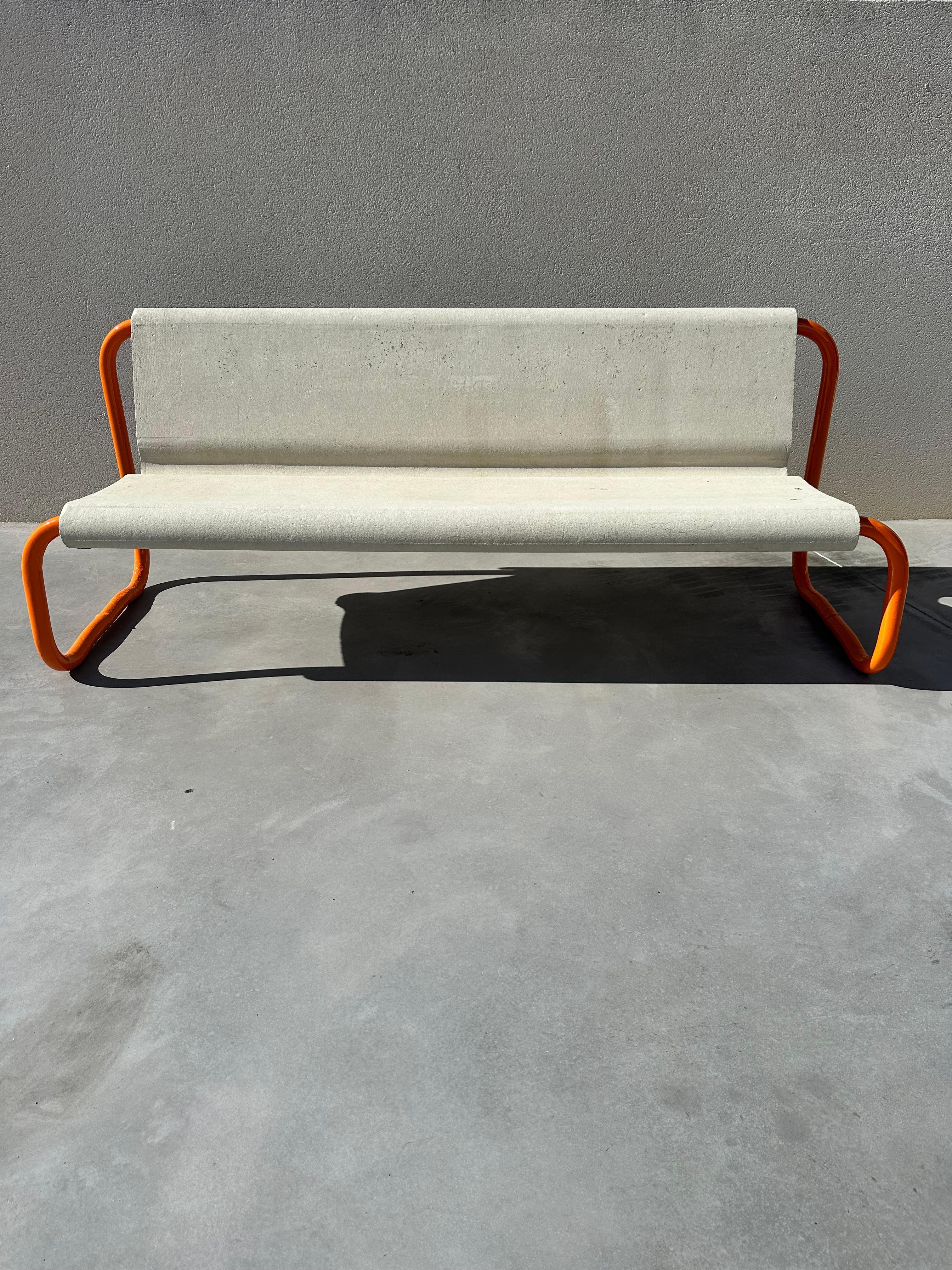 Mid-century floating bench designed by Swiss Architect Willy Guhl.

Seater concrete monocoque is in good condition and the tubular steel base has been completely restored, sanded and repainted with orange paint. Work carried out by a professional