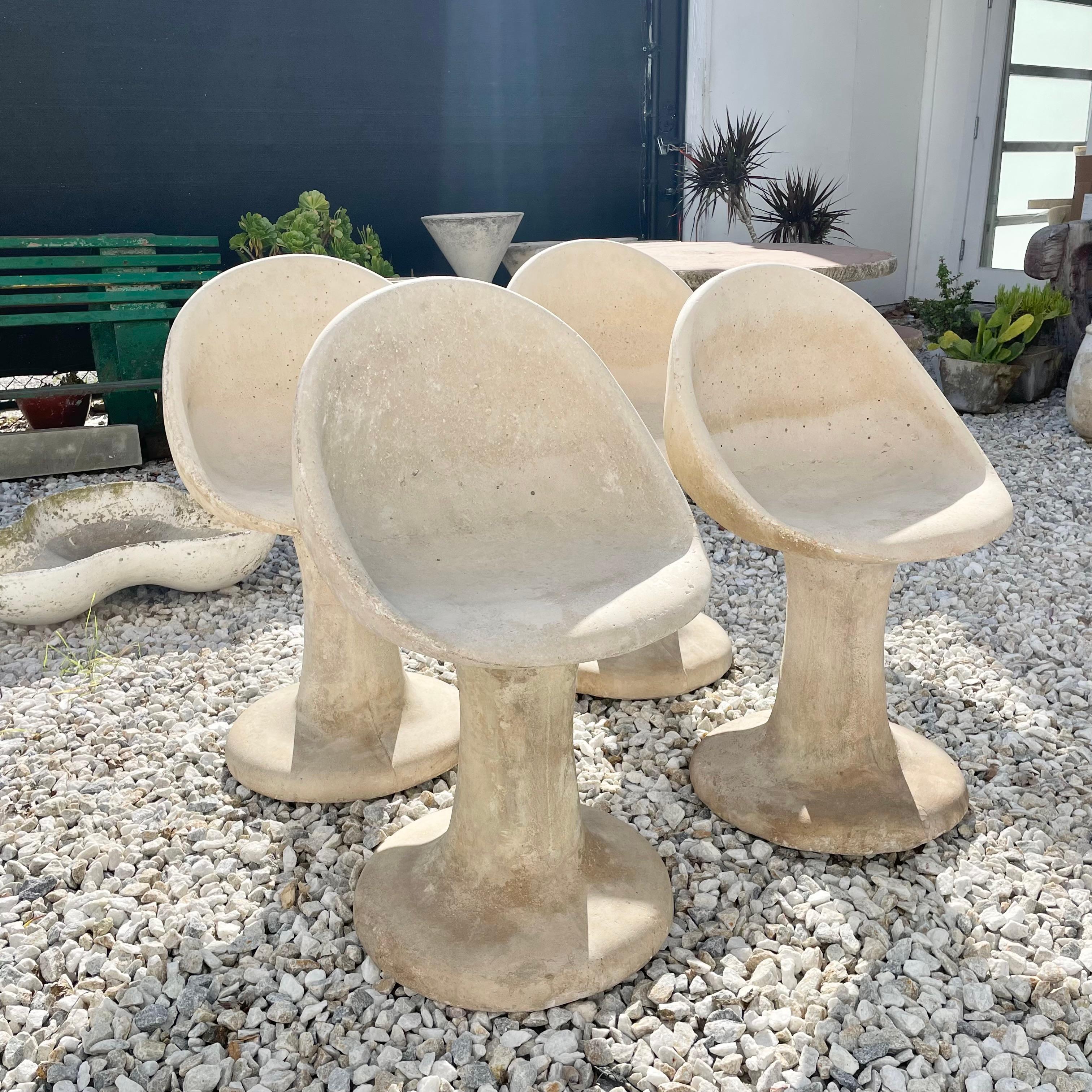 Unique set of concrete aggregate chairs with a Tulip style base. Very unusual chairs with light patina and nice coloring. Good condition. Extremely heavy and well made. Priced as a pair of 2 chairs. 2 sets (4 chairs total) available.