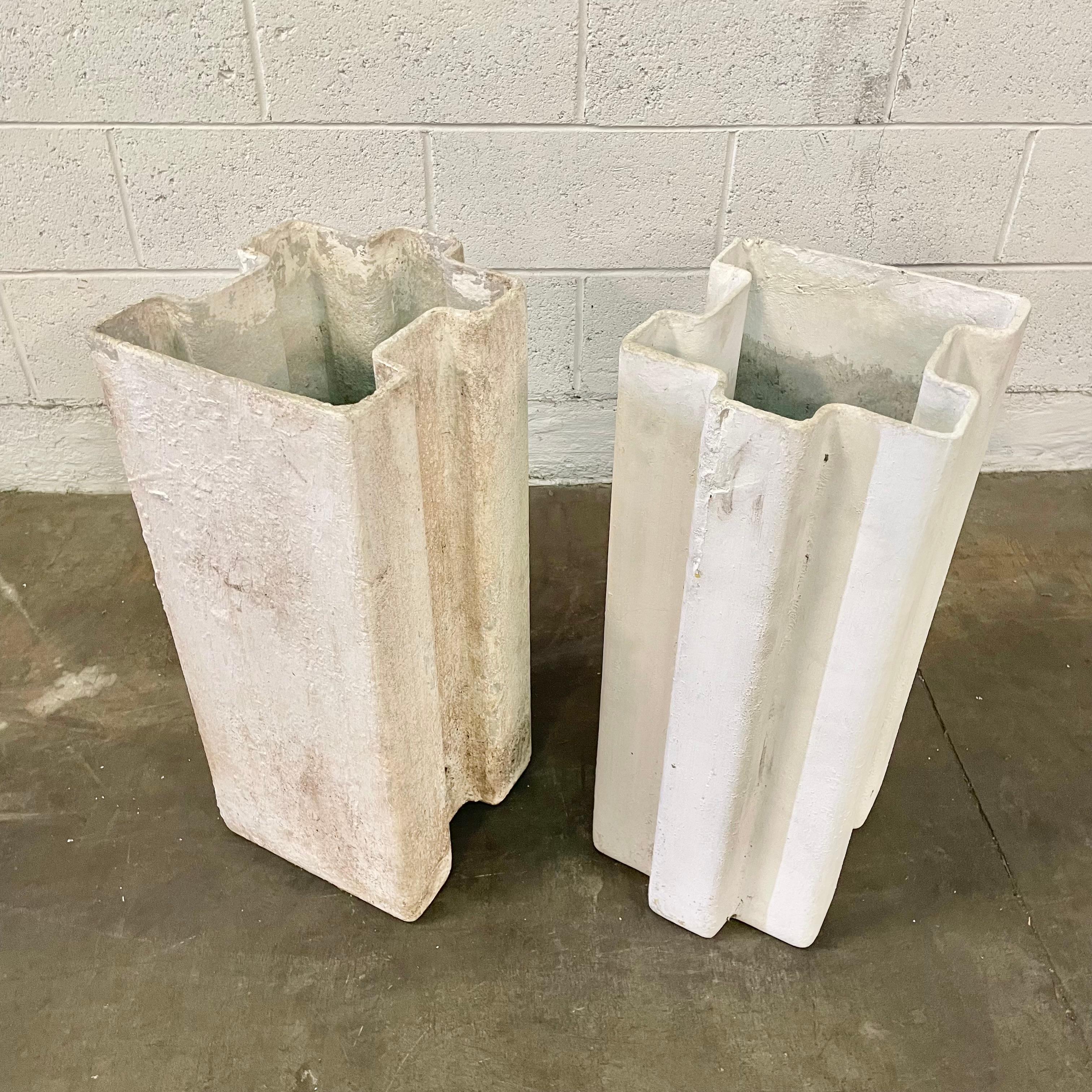 Fantastic sculptural piece by Swiss architect Willy Guhl. Tall planters shaped like  jigsaw puzzle pieces. One is painted white while the other is in the original concrete. Cool sculptural piece for indoors or outside. Great standalone piece of art.