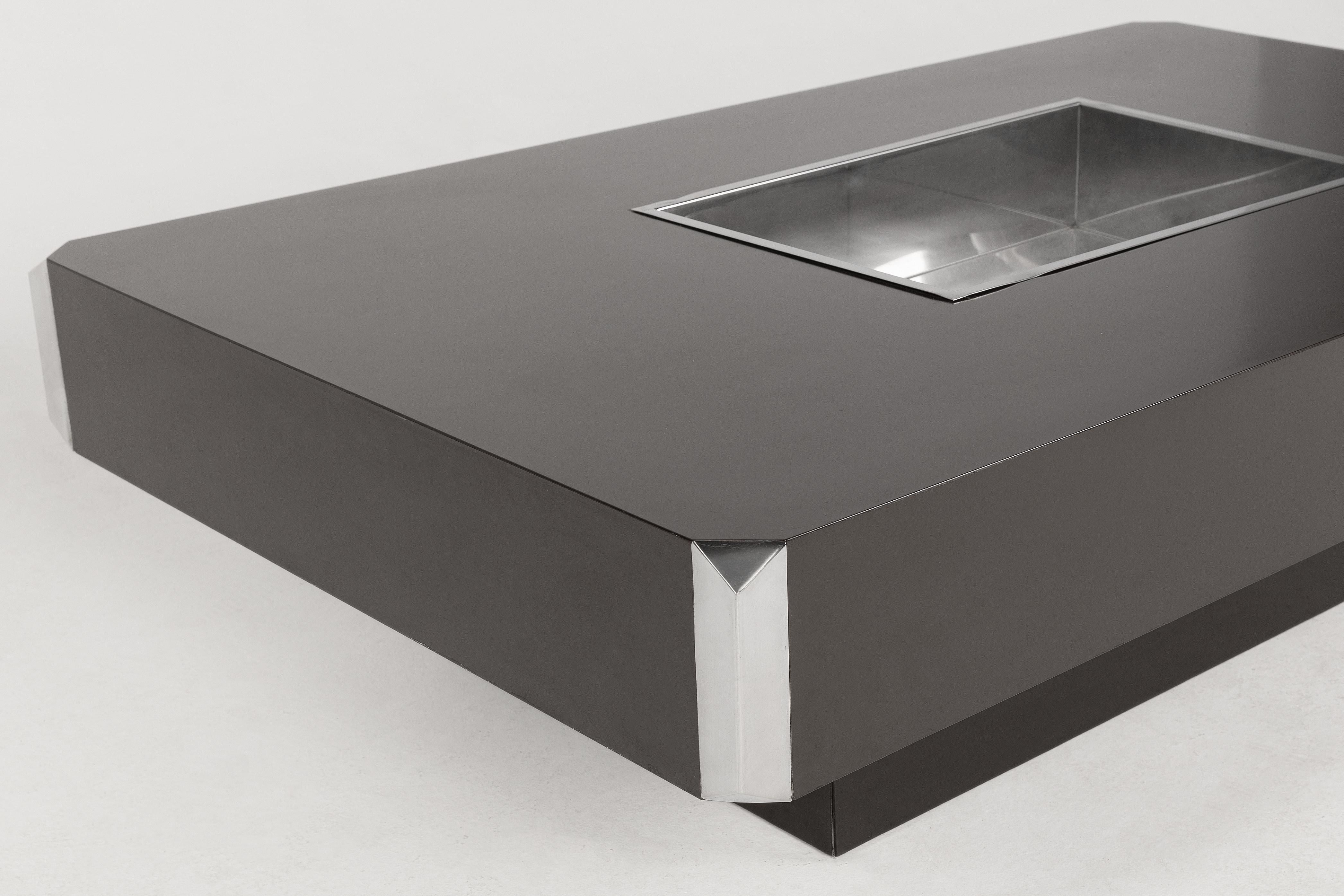Iconic Willy Rizzo coffee/bar 1970's table in black. Signs of wear at the bottom of the table- not very visible. Lacquered black wood with parts and details in polished steel. 