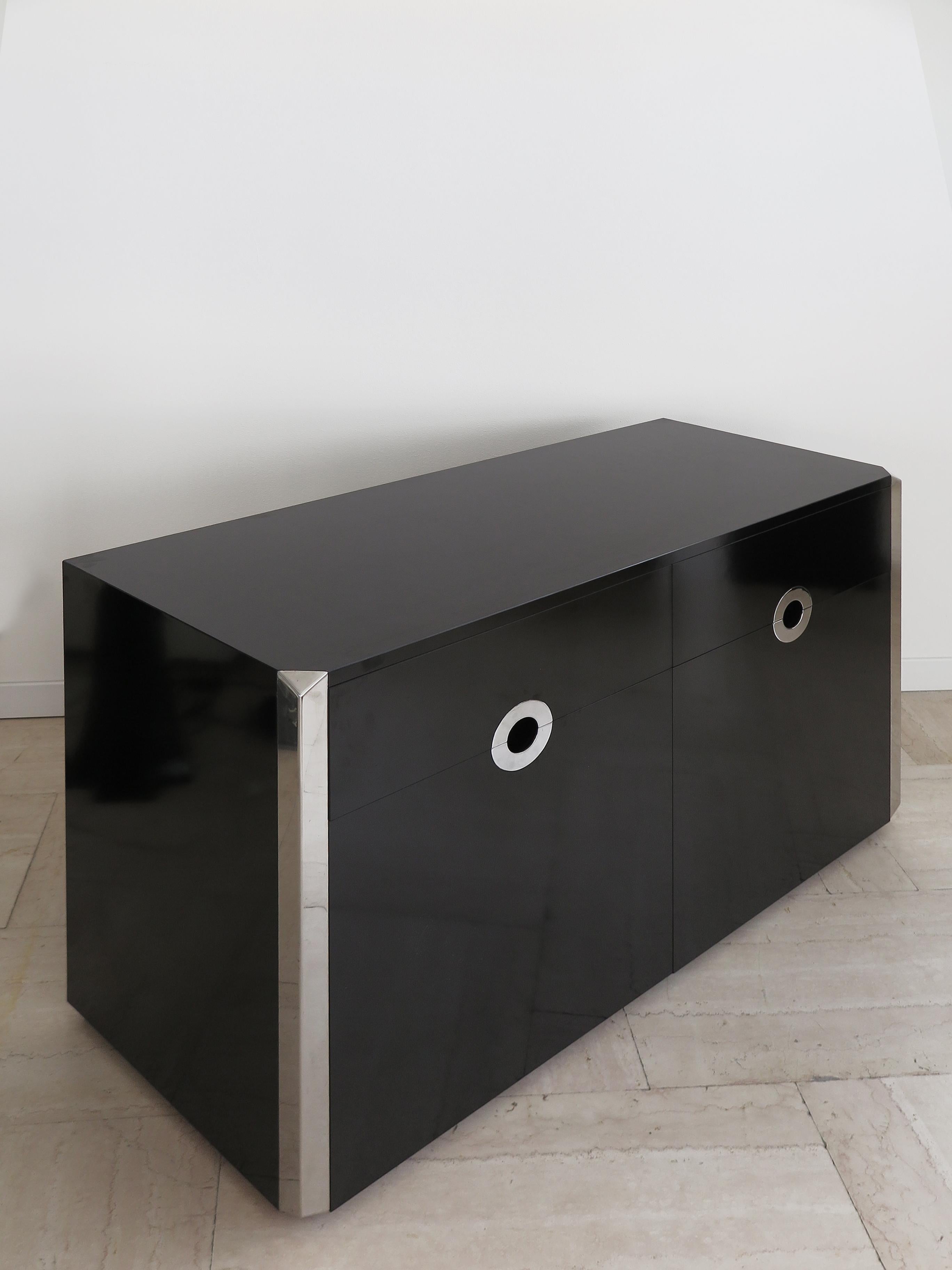 Sideboard credenza designed by Italian photographer and designer Willy Rizzo and manufactured by Mario Sabot with a wood frame covered in black laminate and steel details with two doors, two drawers and with with shelfes inside, 1970s

Please note