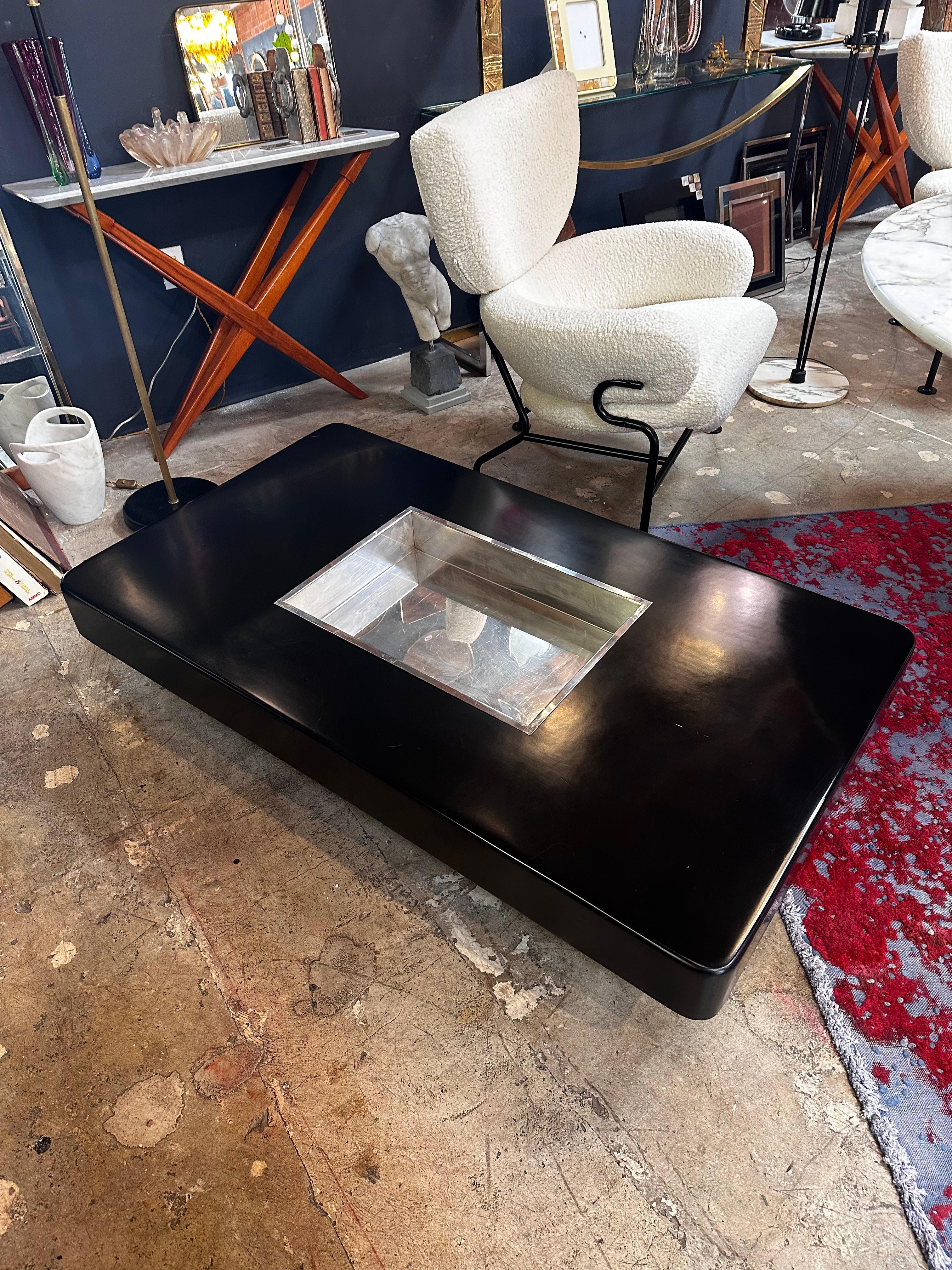 The Willy Rizzo Black Lacquer and Chrome Bar Coffee Table from the 1970s is a chic and distinctive vintage piece. Designed by Willy Rizzo, it combines black lacquer and chrome elements to create a sleek and modern aesthetic. With its bar-like