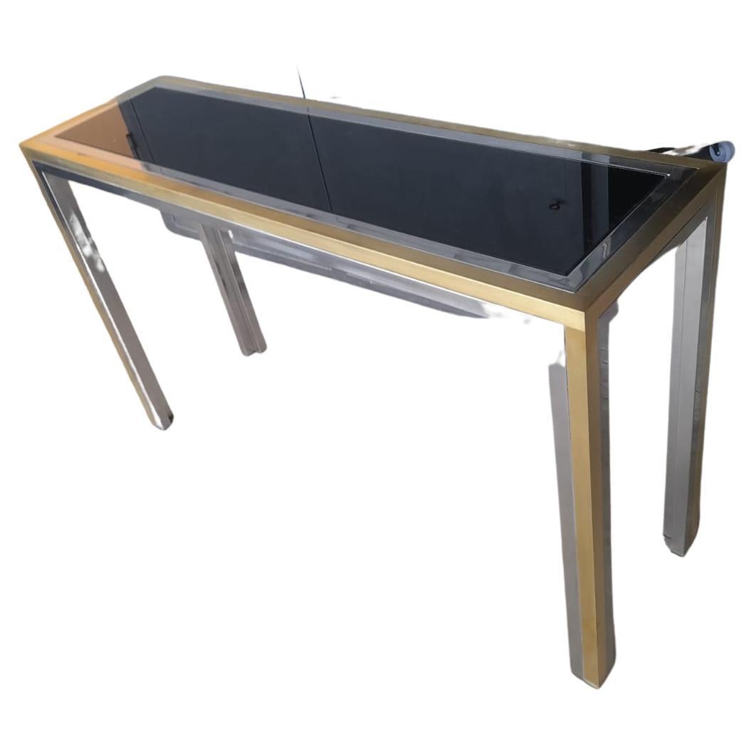 Willy Rizzo console table from 1970s, gilded brass and black smoked glass top
Measures: Cm 120 x 35 H 74.