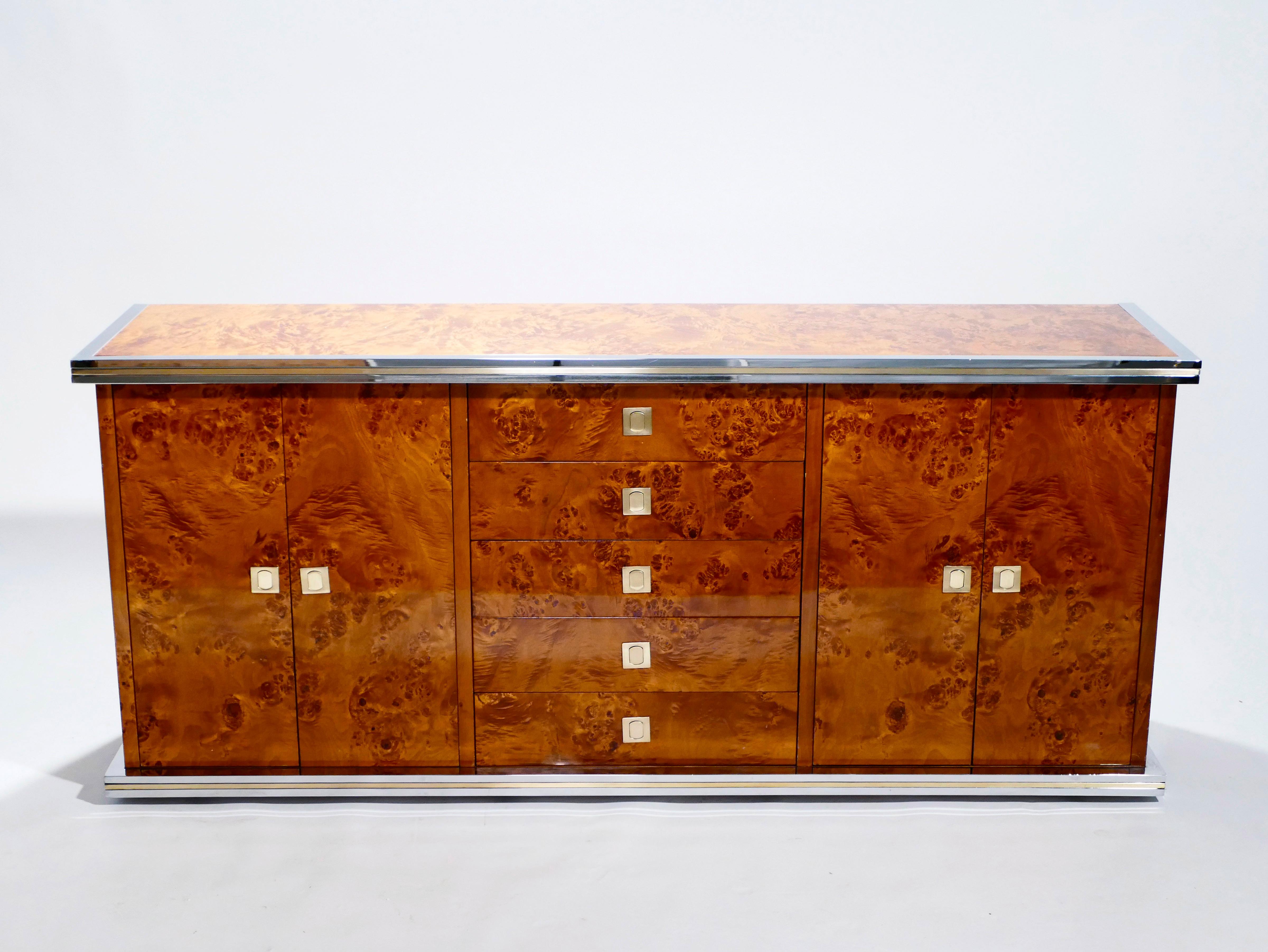 Rich burl wood is the eye-catching chief material in this beautiful, rare credenza by Willy Rizzo. The wood sides and top swirl and ripple into shades of caramel and coffee brown, for a warm, glossy look. Brass and chrome accents, along the clean