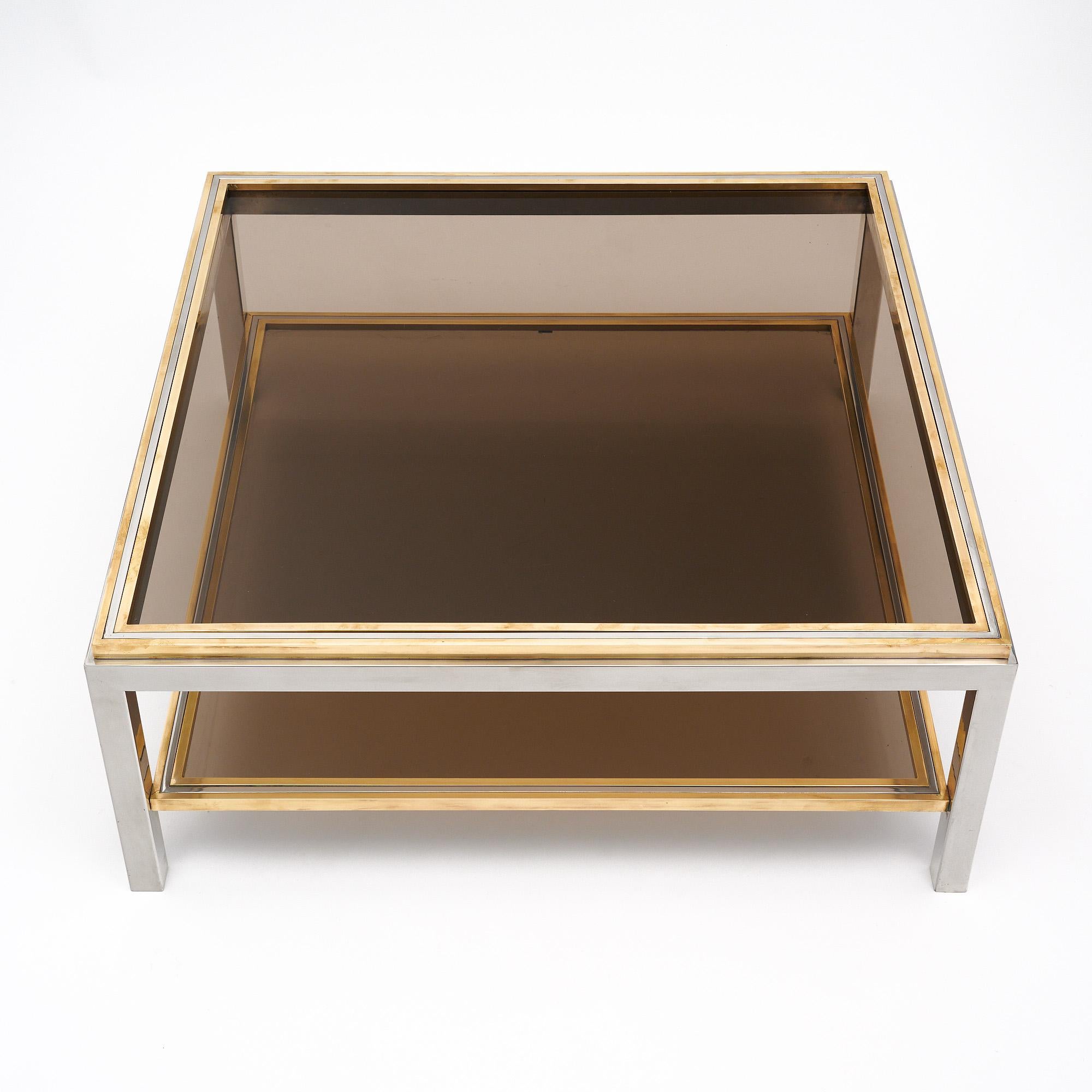 Rare Willy Rizzo coffee table from Italy. This piece is made of chromed steel with the top and lower shelf of smoked glass. The piece features brass trim throughout. Signed.
